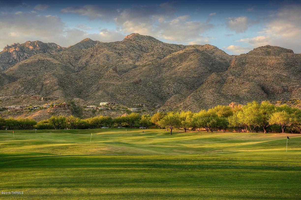 Gated Ventana Canyon Golf Villas with golf course and city light views. Charming 2 bed, 2 baths with courtyard. This townhouse sits on a wonderful lot close to the end of the street and near the heated community pool and spa.  Spacious open feeling with high ceilings, light and bright. Backyard includes outdoor fireplace and room for entertaining overlooking the 11th hole of the Mountain course. Furniture is included in price.  Buyer to pay 0.5% HOA Capital Reserve fee at closing.