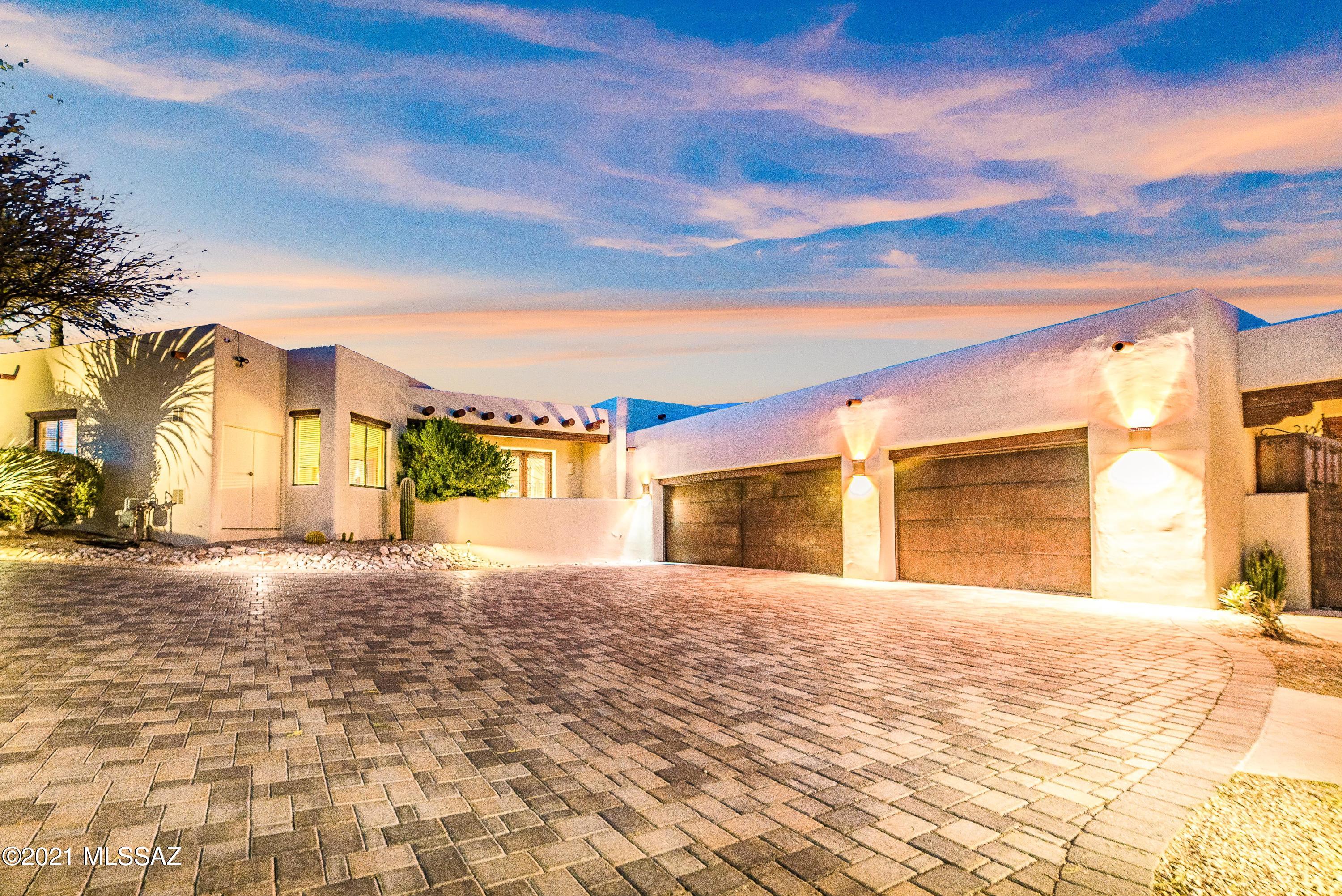 Beautiful Contemporary Hacienda in La Paloma Estates. Incredible resort lifestyle with La Paloma Resort and Country Club within walking distance. Private golf, tennis, Olympic pool, health club, and restaurants are available as part of a membership to LPCC. 3 bedroom + den/office, 3 bathroom, 3,903 Sq Ft main home with a luxurious 964 Sq Ft private guest house. High vaulted ceilings, flagstone and wood floors, and breathtaking outdoor spaces highlight this private cul-de-sac home. Chef's designer kitchen with fabulous touches and high-end finishes and appliances. The Master Bedroom is reminiscent of a luxurious resort suite that encompasses two large walk-in closets, walk-in shower, and a bathroom larger than many bedrooms. Views that stretch from the Santa Catalina Mountains through La Paloma Canyon No. 7 and then following the private wash and desert landscape highlighted by the silhouette of the remarkable Hacienda Del Sol Guest Ranch sitting on the hilltop. Words and pictures alone cannot capture the beauty of this timeless property, as it exhibits the well thought out designer finishes and modern technologies. Five fireplaces, oversized 3 car garage with heated and cooled storage, paver driveway, putting green, pool, and private backyard. The lifestyle presents an incredible opportunity to either take advantage of the proximity of the Resort and Club amenities or relax or entertain at home with your friends and family.