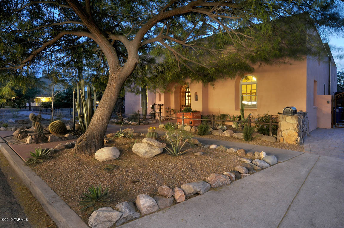 Net Zero Energy Solar historic Maish-Normart cira 1875 is pre railroad era Sonoran Transitional architecture, has 22'' thick Adobe walls & 18'Saguaro rib ceilings. Original entry room  with a fireplace , Etched & scored concrete floors,Recycled Yellow Pine Plank wd floors, dual pane low e windows throughout, Solar Panels, Solar tubes, Solar Water, Gallery lighting, 5 bedrooms , 4 bedrooms along with private baths downstairs, dining hall, Gourmet's kitchen w/solid Mesquite Cabinetry, Granite counters, center island w/copper sink, Cherry Viking appliances  including double refrigerator + freezer, 6 burner stove/double oven, dishwasher, compactor, wine cooler, microwave & warming drawer, eat-in kitchen family room, finished basement, loft office, master suite luxurious bathroom upstairs.