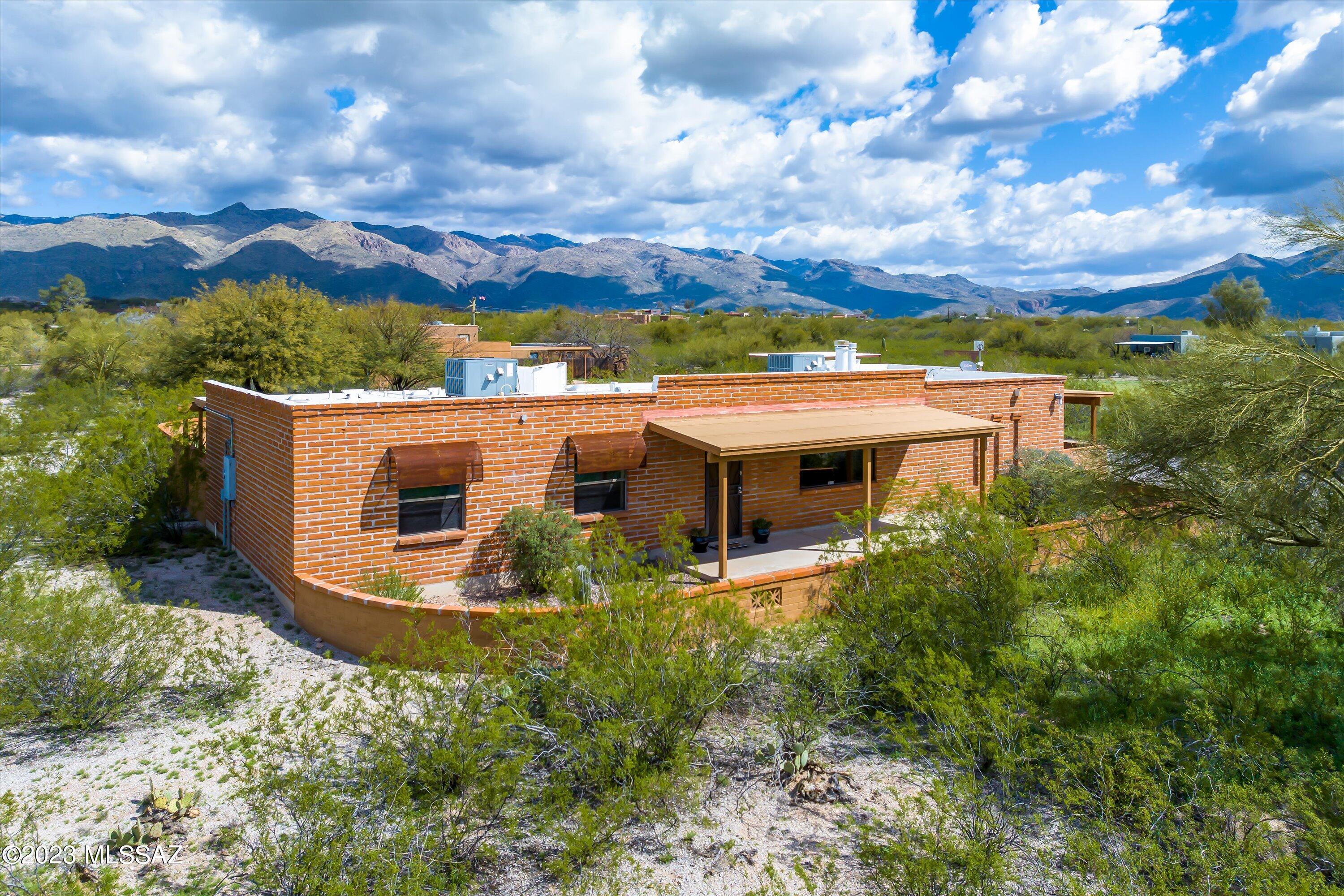 This beautiful ranch style home sits on 3.3 acres w/ a pool & has incredible mountain views! Home features 2 HVAC units, is updated throughout & has 2 Primary suites, both w/ huge walk-in closets! Split bedroom floor plan. Primary master has fireplace & private patio w/ Rincon Mountain views. Laundry is in utility/office room which could also be the ''4th bdrm''; Possibilities! Separate workshop & storage building w/ 2 car carport. Easy garage conversion, use as tack room/hay storage or turn it into a guest house (plumbing & electric already there)! Property zoned for horses; Bring your panels & ideas! Half of lot extends East (flat & vacant) +covered animal shelter or use as more covered parking. Space for RV/Toys. No HOA! Privacy abounds! Ready for you to move right in!
