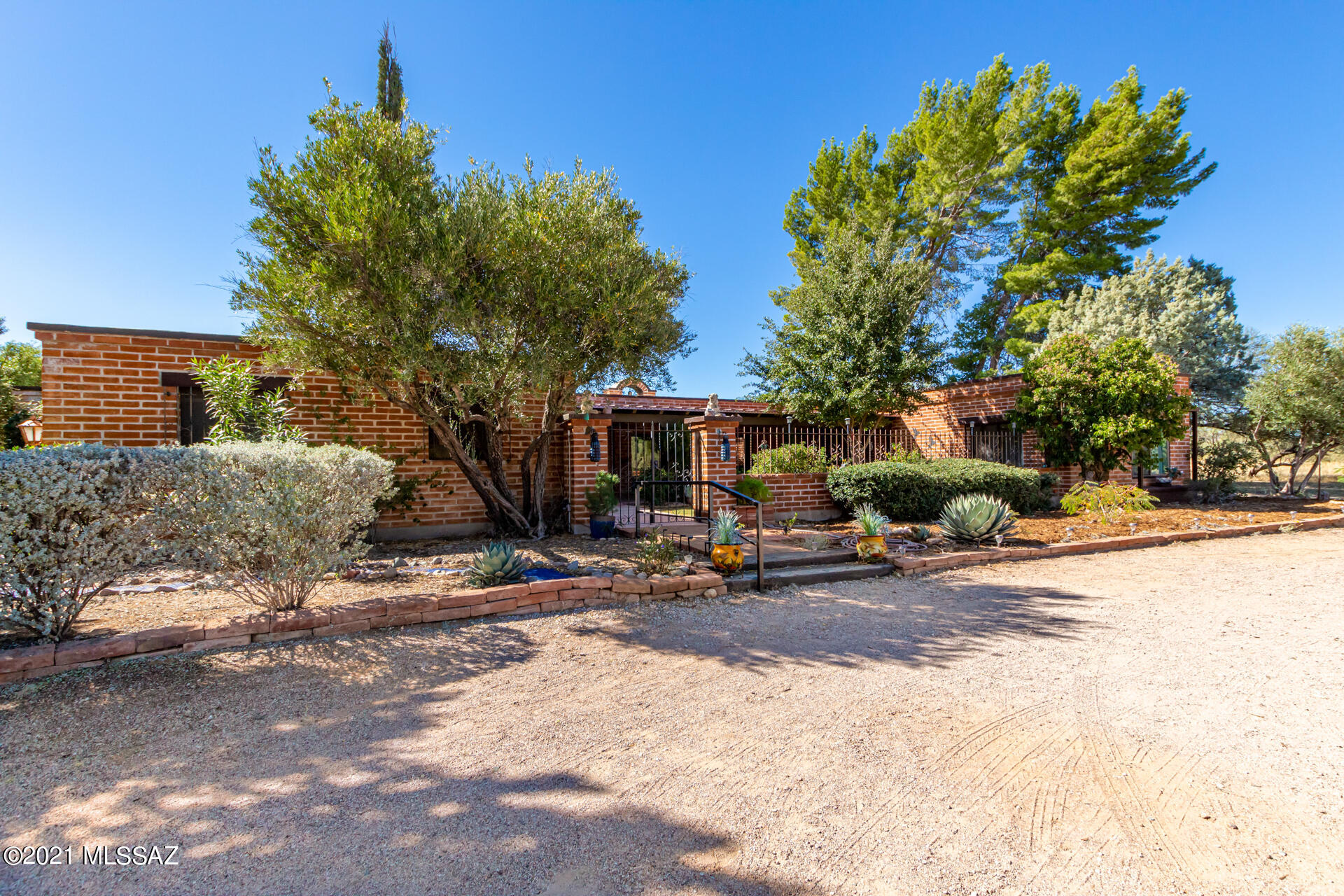 A must see in the Tubac Country Club Estates! This lovely brick home includes an inviting covered patio in a beautifully landscaped courtyard, where you will enjoy the fountain and view of majestic Elephant head in the Santa Rita Mountain Range. From the courtyard, large glass sliding doors provide entrance to an expansive living area which includes a wood bean ceiling and flagstone fireplace. Sonoran & Mexican tile bring a warm ambiance to this home. It has 3 Bedrooms, an office, formal dining room and 2 1/2 bathrooms. There is a circular driveway leading you to an attached large double garage on .09 acres. The backyard is totally enclosed by a brick wall fenced. You are minutes away from fine dining and world class golf. Don't let this one get away!