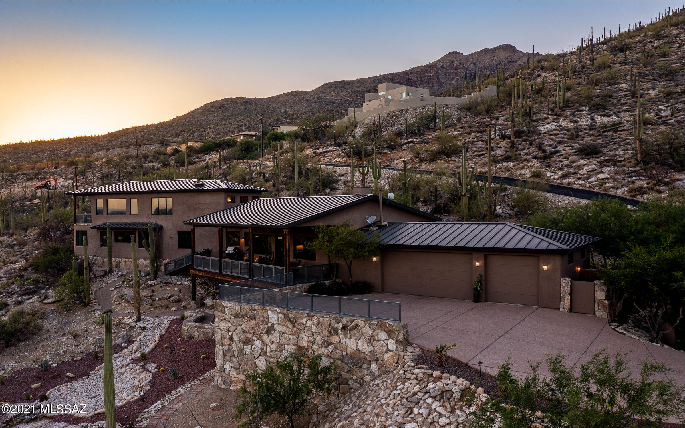 Sweeping city & mountain views! Elegant, contemporary 5 BR, 5 BA home perched high above the city on 3 acres w/mesmerizing views! Features gourmet kitchen w/luxury finishes, butler's pantry, warming drawer, sub-zero refrigerator,  new ice maker, custom cherry cabinetry, freshly refinished red birch floors. Private master suite & office/den wing w/covered balcony, family wing w/built-ins. Lower level suite w/ private patio may be used for guest qtrs, home theater and/or gym. Steel frame construction, metal roof, alum clad wood windows, 3 AC units, split floor plan. Gated dog yard, sports court, native stone retaining walls thru-out property. Spacious, extended deck for outdoor living. Additional parking avail in back of property. No HOA!