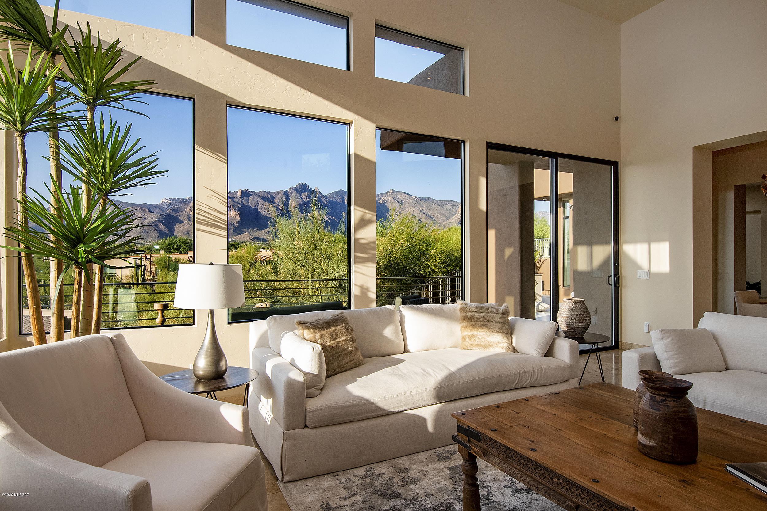 GORGEOUS!!! STUNNING CONTEMPORARY w/ UNBELIEVABLE MOUNTAIN VIEWS & PRIVACY in MOST PRIME, CONVENIENT LOCATION! Kevin Howard designed. 5 bedrooms-main house, plus MOST AMAZING 955 sqft GUEST HOUSE w/ 16 ft ceilings! Private gate! Super high ceilings, large windows, travertine & wood flrs, 2 fireplaces. Cherry kitchen w/ granite & ss appliances. Lovely breakfast bar. UPGRADES GALORE: OWNED SOLAR!, A/V equipment (fully loaded!), 2 wine refrigs/bar area, 2 Murphy beds, rolling shutters, specialty lighting, built-in desk/closet/BBQ. INCREDIBLE outdoor balconies/patios. Perfect for entertaining or just admiring the SPECTACULAR views! Best Tucson location close to La Encantada, downtown, U of A, shopping/restaurants. No HOA-PHENOMENAL VALUE! Many recent upgrades! Watch attached videos.
