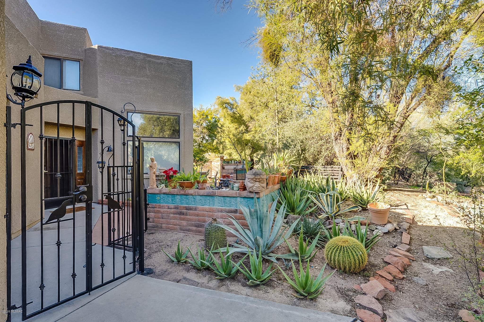 Rare opportunity to own a Beautiful townhome in the desirable Champagne at Starr Pass! Gated front patio with mature vegetation gives this home a warm, welcoming feel. Great floor plan with master on first floor. Formal dining room with built in custom wine chiller! Soaring vaulted ceilings with large windows allow for an abundance of light. Custom Stair rail leads to the open Loft, second bedroom and full bath on upper level. Delightful patio for hours of enjoyment. HOA covers: community pool, spa, exercise facilities, grill & common area landscaping/irrigation. Close to 27-hole Arnold Palmer Signature Golf Course, J W Marriott Resort & Spa and miles of biking and hiking! Minutes away from downtown, Pima College and the University of Arizona. Enjoy Resort living in beautiful Starr Pass!