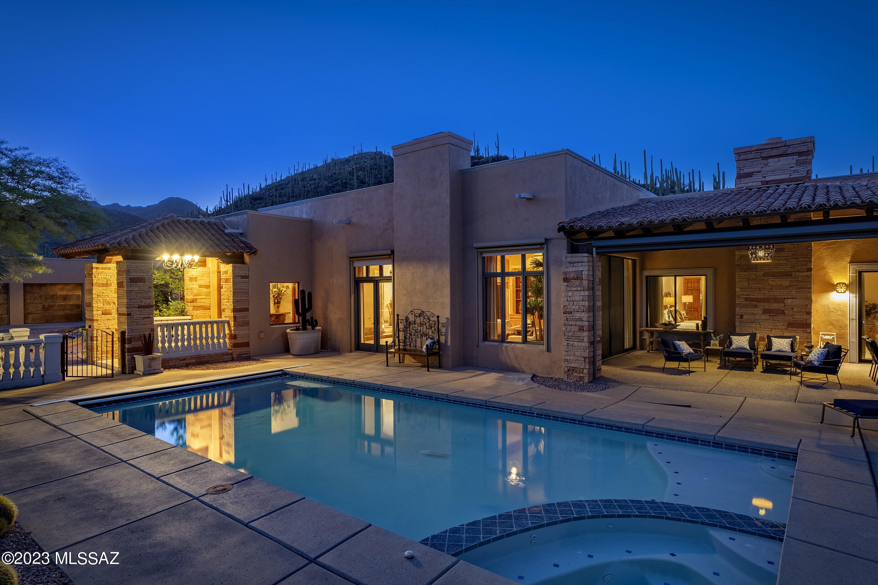 Priced $95,000 less than recent appraisal! Situated on a private and commanding 	10.46 acre view lot, backing up to the Saguaro National Park West, with soaring city and mountain views that stretch out over the valley below, creating the perfect backdrop from which this one of a kind homesite was selected. Maximizing the home's dramatic relationship between interior and exterior spaces is achieved through careful design and placement of structure, with connectivity to the protected Saguaro studded desert landscapes. From the privately gated approach one is received by a cohort of lush vegetation that celebrates the natural beauty encompassing the residence. Solid in form, with thick masonry construction, offers a sense of permanence while evoking a feeling of lifestyle that responds to the unified dialog between the architecture and the adjoining desertscapes. The entry opens onto the main body of the home, designed to offer both scaled social spaces, ideal for entertaining, as well as the privacy of a secluded retreat.

The open floor plan complements the soft interior textures and accenting wood tones, while taking full advantage of filtered natural light through an array of large picture windows that frame the visual horizon.

The interior spaces offer unmatched fit and finish, with antique motifs and custom built in millwork providing material continuity to the overall design aesthetic. The kitchen features custom cabinetry, set against granite countertops, and fitted with professional series appliances while carefully choreographing the user's movement through the space.

The Southeast end of the residence comprises an oversized owner's suite, with a large custom dressing closet, and a luxurious spa-like bath. Walls of glass fill the suite with soft morning light, while providing access to the covered veranda. Additional living accommodations are sequestered on the North end of the estate, with a junior primary suite located on the Southwest end of the property, flanking the cozy study.

The property is serviced by a private well, accompanied by two 1,200 gallon water storage tanks that run through a water purification and filtration system that supplies water throughout the residence.

A series of patios create the framework for the pool and integrated spa, acting as visual centerpiece to the property. Large sliding glass doors off the living room, with automated shutters on the veranda, offer seamless year round indoor-outdoor entertaining. This ultra-private retreat offers both regional design and breathtaking views, while privately situated within moments of acclaimed dining, shopping and entertainment, as well as proximity to hundreds of miles of hiking, cycling and horseback riding trails.