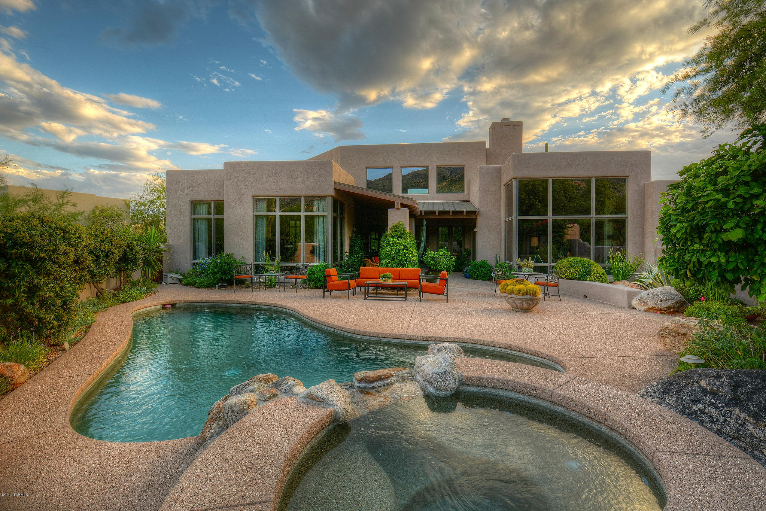 Stunning Soft Desert Contemporary Ultra-Custom w/Dramatic Canyon and Mountain Views. Main living area and master-suite are all on one level with NO Steps - Lori Carroll designed interior that is amazing to capture views from every room. Enjoy the Tucson Lifestyle from this indoor/outdoor designed residence built for gracious entertaining. From the beautifully landscaped romantic courtyard entry, spacious covered patios to the Anasazi stone fireplace, Andersen floor to ceiling windows, Dacor/SubZero stainless appliances, granite counters, scored color-concrete floors, luxurious built-in office/study, 8' solid wood interior doors, Hunter Douglas window coverings,Pebble-Tec pool/spa/water feature,, aggregate concrete driveway, finest finishes/hardware and style.Immaculate turn-key perfection.