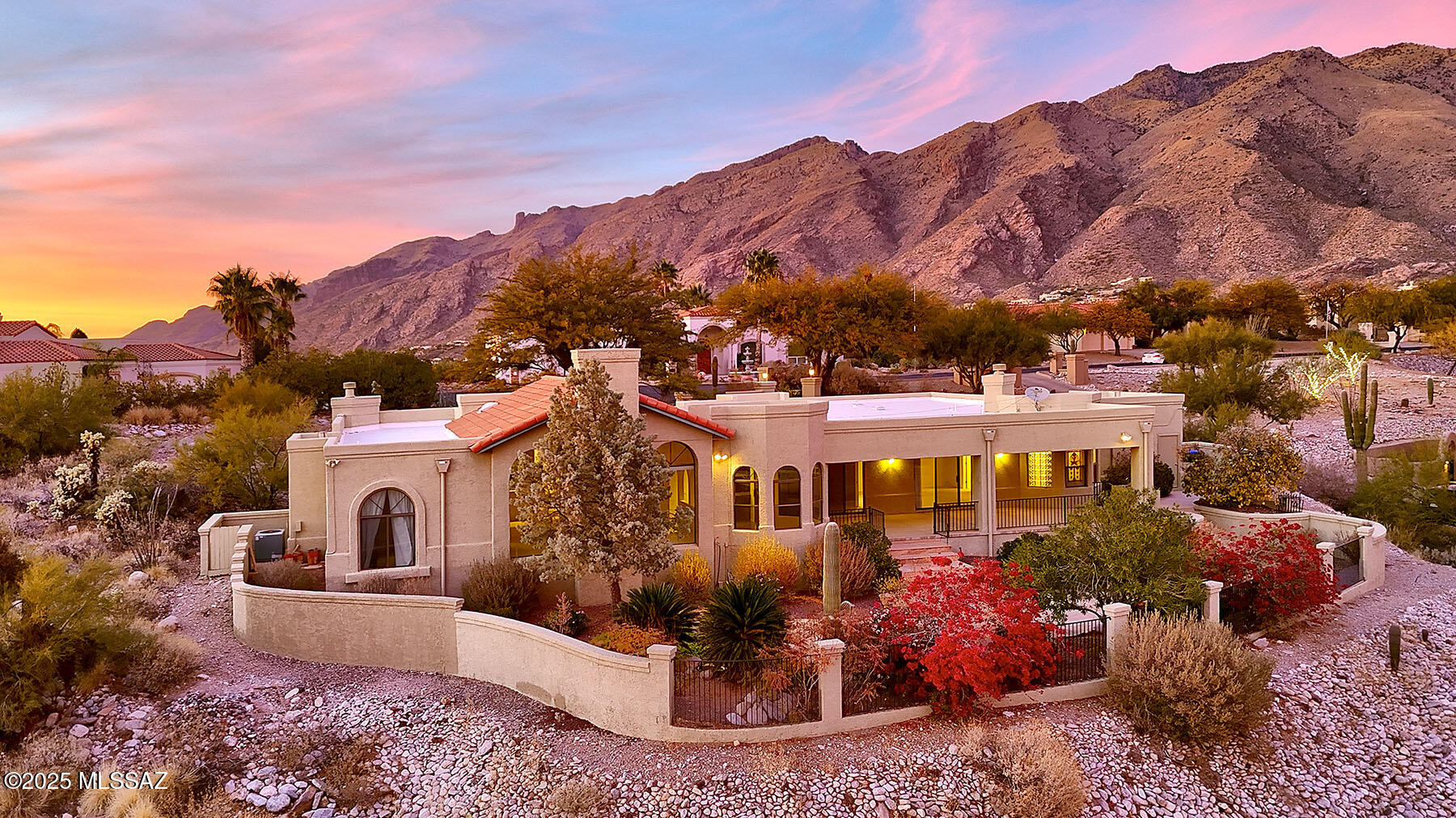 Nestled at the end of a quiet cul-de-sac, this private, gated home in the highly sought-after Ventana Vista community offers breathtaking views of the Catalina Mountains and city lights. Designed by renowned architect Rob Robinette, the home features an open and airy layout, highlighted by a large living room with expansive picture windows that frame the stunning vistas. The remodeled kitchen is a chef's dream, boasting custom cabinetry, sleek granite countertops, a 4-burner gas cooktop, a convenient prep sink in the island, a convection oven, and a cozy eat-in area where you can enjoy your meals with a view. The spacious primary suite offers a tranquil treat, complete with a two-way fireplace, a large walk-in closet, and dual vanities for added luxury. Two guest rooms are complemented by two additional versatile spacesone a cozy family room with its own fireplace, and the other an ideal office or den. The guest baths are nicely sized, with one featuring a trendy modern remodel. A long, aggregate driveway leads to a charming gated courtyard with a soothing fountain, setting the tone for the home's inviting ambiance. The backyard is an entertainer's paradise, showcasing magnificent views, a large covered patio, and a peaceful koi pond. The home is finished with easy-care Rojo's concrete flooring, dramatic arches, and beamed ceilings throughout, adding an abundance of character and detail to this exceptional property.