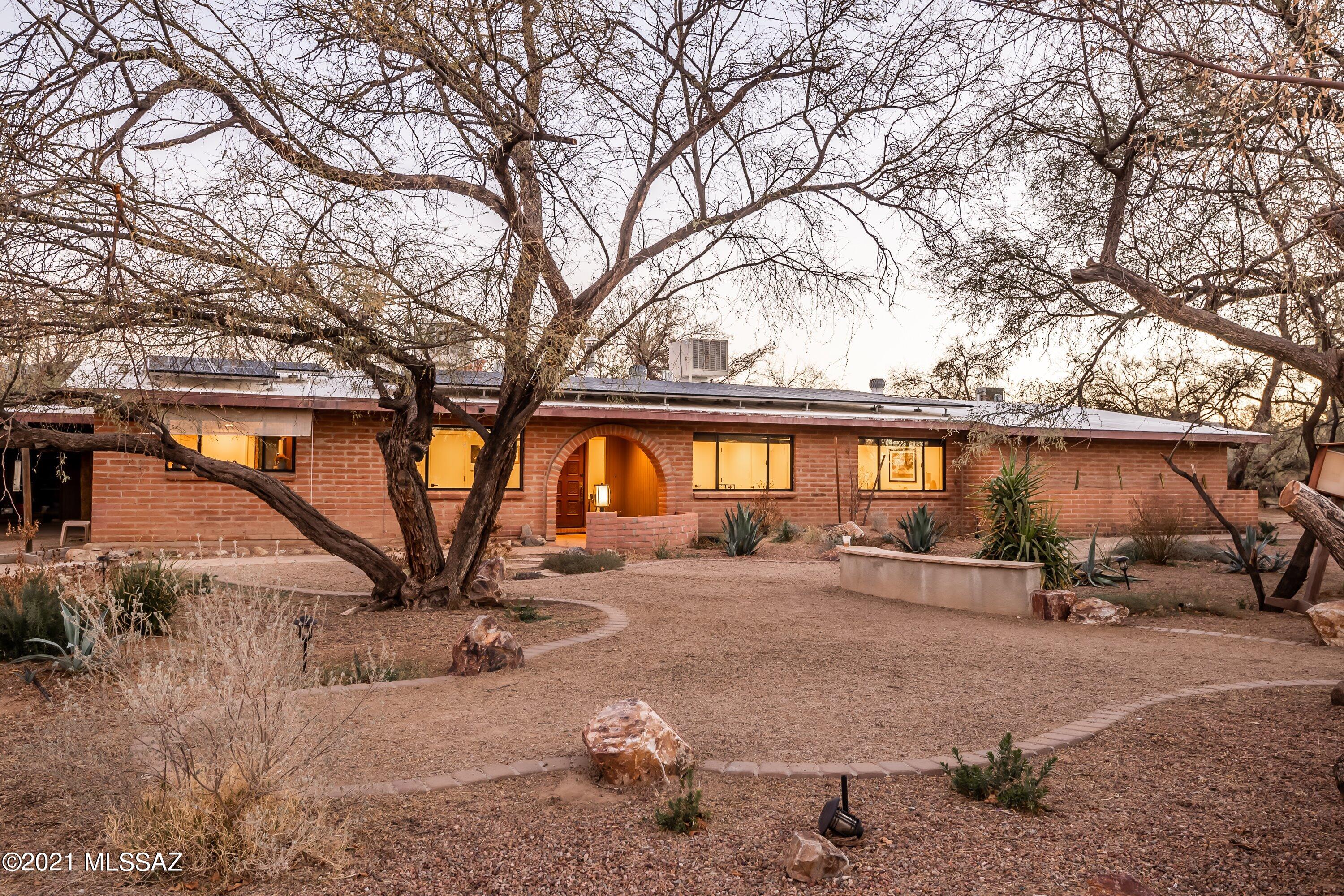Calling all horse lovers! Come see this completely remodeled ranch style home on coveted Woodland Rd. Stunning mountain views on 3.42 acres and PRIVACY all while living in the city. Spacious main house has 3 bedroom, 2.5 baths, with den.  Attached casita with 1 bedroom, 1 bath. Woodbeamed ceilings in living room, den offers custom built-ins, and 2 wood burning fireplaces. Covered patio and detached storage/ workshop. Private well. Recently recoated roof with 7 year warranty. Large pool AND move-in ready horse facilities! Including 120x120 ft arena, two 50-ft round pens, 5 tack sheds... the list goes on! Ride across the street for access to hours of trail riding. To see more regarding the business run by the owner, go to http://heartofthehorseaz.com.