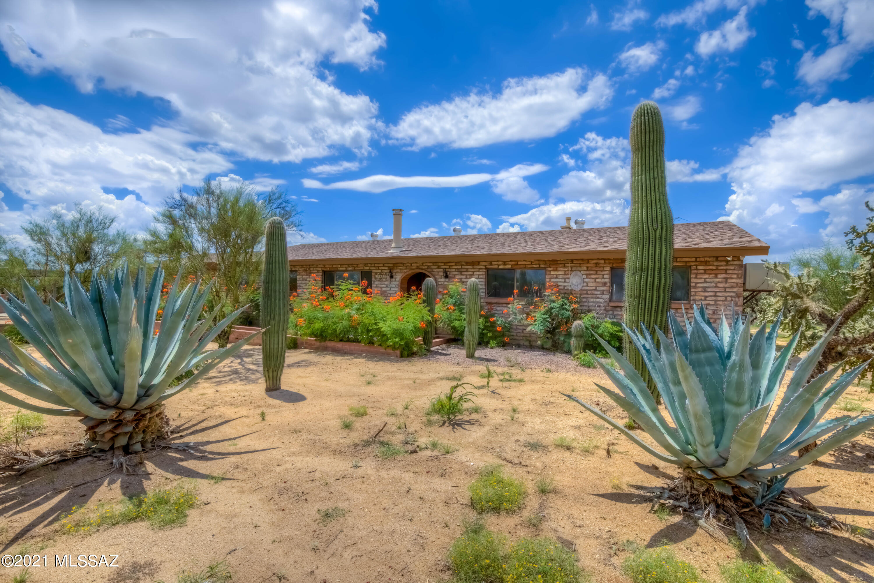 Newly remodeled burnt adobe dream home on 4.75 acres of horse property in highly desired NW Tucson! 4 bedrooms AND an office with separate entrance. New pretty concrete overlay flooring throughout. Oversized rooms, large closets and gorgeous views. Enormous garage with workshop.  Mountain and desert views at every turn. Newer HVAC with dual cool option. Newer water heater, new paint, bathrooms, and newer kitchen. Very short distance on county maintained road to get to private entry. Country living just seconds from everything you need.  Yard area includes lighted horse arena, four covered stalls with lighting, and tack room.  Basketball court and walled-in area for vehicles, camper, dog run or amazing enclosed garden area (electric and water available there too!).  Hurry!