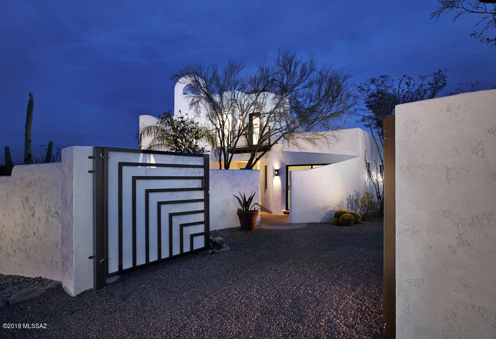 A rare opportunity to own a dramatic, completely updated compound in one of the most sought after locations, The Old Foothills! Located just 10 min from Banner UMC/ UA, this sophisticated, casually elegant home offers privacy w/breathtaking views from every room. Ideal for a multi-generational family, this property features a 2,417sq.ft, 3BR/3BA main home  & a large 928 sq.ft detached 1BR/1BA guest house. Concrete floors, dramatic fireplaces in the liv. rm & master bedrm, new Gourmet Kitchen w/white cabinets, stainless appliances, custom tile work & large island w/gas range. Upon entering the private entry gates, you are welcomed by a soothing fountain, stunning views of the Catalina Mountains & magnificent outdoor living space, creating a constant state of euphoria for the new owners.