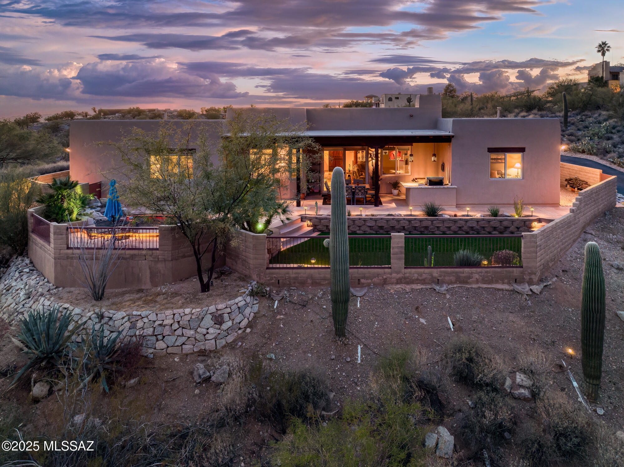 Perched on over 3.5 acres of tranquil hilltop, this charming contemporary Southwest-style custom home offers an unparalleled blend of luxury and serenity. Exquisite panoramic views surround the property, creating a stunning backdrop for daily living. The thoughtfully designed split-bedroom floor plan features 4 spacious bedrooms and 2.5 bathrooms, including a recently renovated spa-like primary bath and generous closet space. The gourmet kitchen is a chef's dream, boasting solid pecan cabinetry, gleaming granite countertops, a breakfast bar, and a cozy dining nook. It flows seamlessly into the expansive great room, perfect for both relaxed living and elegant entertaining, with ample space for formal dining. Custom touches throughout add warmth and sophistication. (CONTINUED) Outdoors, a covered patio with a built-in cooking area overlooks the meticulously designed, low-maintenance landscaping. The beautiful "spool" offers year-round enjoyment as both a spa and pool. A three-car garage includes one bay currently configured as a workshop, catering to hobbyists or additional storage needs.
With a recently recoated roof and fresh interior and exterior paint, this home is move-in ready. Experience the best of Southwest living in this one-of-a-kind retreat that perfectly combines comfort, style, and breathtaking natural beauty.