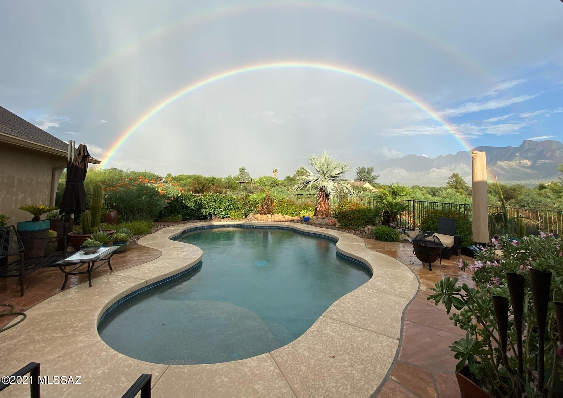The panoramic Catalina Mountain views from this exceptional home is a rare opportunity to own in the heart of Oro Valley on an acre of professionally landscaped property w/unbelievable privacy. Your oasis is filled w/established cacti & succulents, enhanced by the sound of trickling water from 3 water features, 5 fruit bearing trees, all landscaped on a smart phone-controlled timer. Inside the expanded & remodeled home, you will find your beautiful kitchen w/rich black glass Jenn-air appliances, custom alder cabinets w/self- closing drawers. The flow from kitchen to dining & family rooms keeps you connected while you enjoy the remote-controlled bee hive fireplace. The view of the pool & mountains from the 500 sq. ft. vaulted covered patio w/ceiling fans is priceless.  WOW!  This won't last