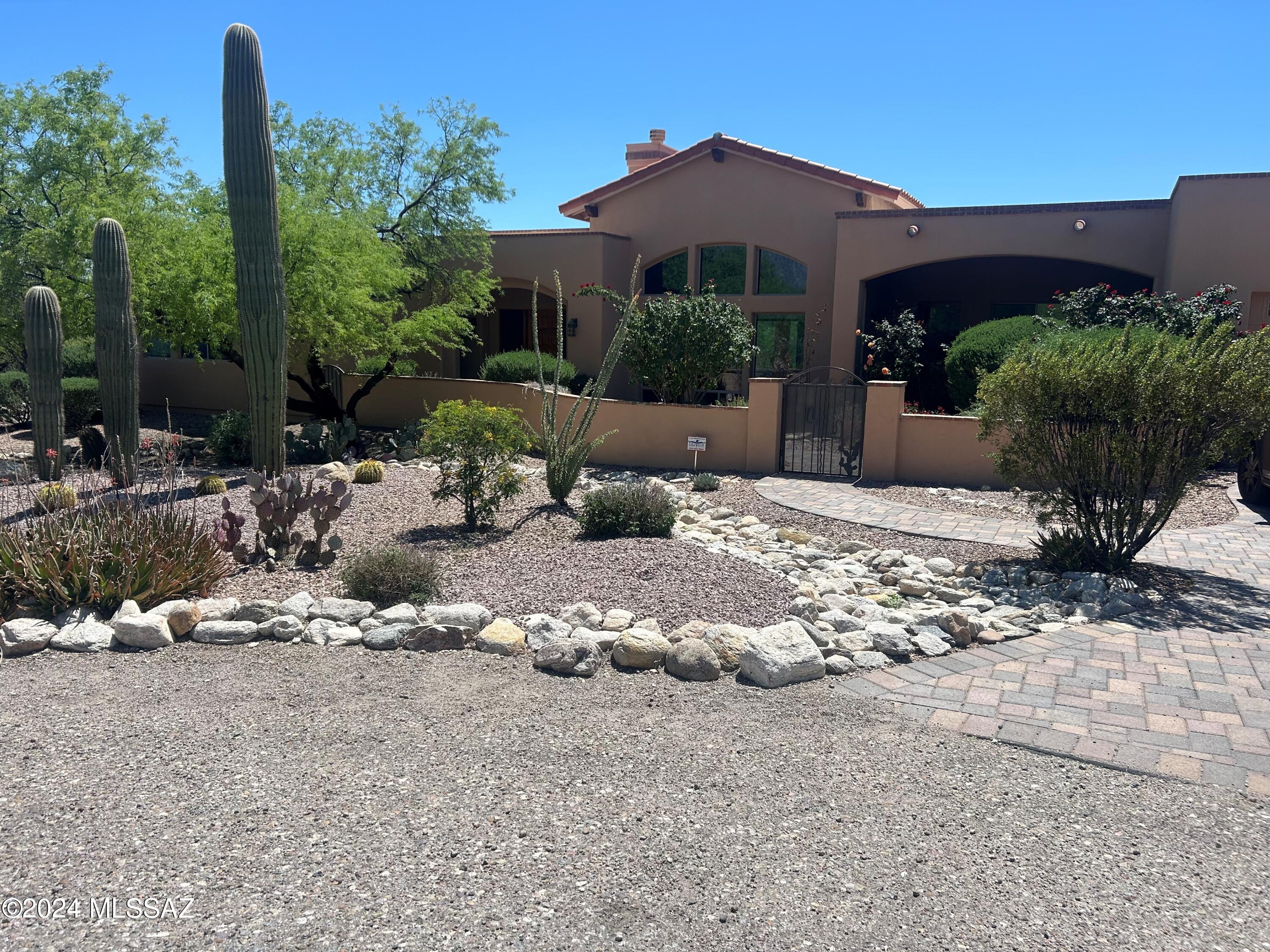 Live in the heart of Tucson Foothills tucked w/i a cul-de-sac in a great neighborhood with lush, mature surrounding yard-scape, masonry walled courtyards, peace & privacy. This gorgeous, 4 bed/4 full bath turn-key fully custom home checks all the boxes-modern & updated, stunning unobstructed Mountain views, single story, solar heated pool, AZ turf grass & pavers on the driveway & walkways. Built by award-winning Milestone Homes, this second owner home is meticulously cared for & features a pool, chef's kitchen, soaring wood beamed ceilings, an open, bright split floor plan, ensuite rooms, tons of natural light, executive height counters & tall cabinetry & majestic windows that take adv of views. The generous master suite with 8ft jacuzzi tub. Dist 16, near Sabino & Ventana Canyon