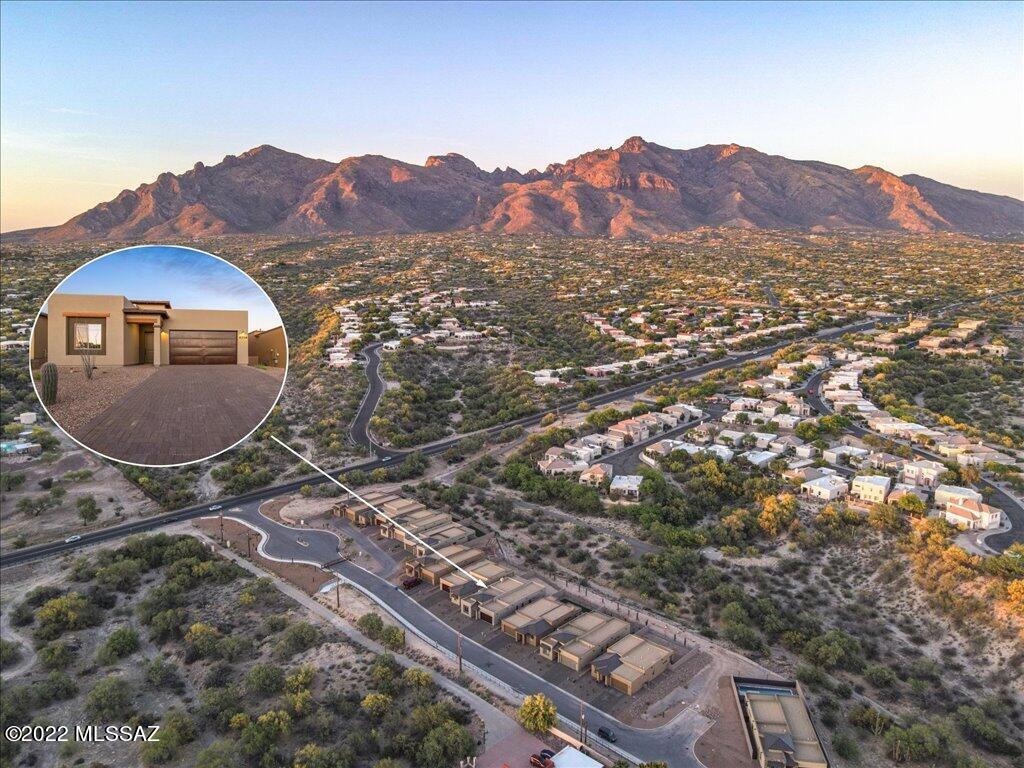 Rare opportunity combining newly constructed home nestled in gated, pocket neighborhood with Catalina Foothills views and great location off Orange Grove between 1st and Oracle. Open floor plan embraces light-filled dining room and great room, as well as spacious owner's suite with private sliding glass door access to extended covered back patio, and bright bathroom with double-sink vanity, custom glass-enclosed shower and separate tub, and large walk-in closet. Completed in January 2022, this premium lot encompasses 2,230 square feet with 4 bedrooms, 2.5 baths, wood-replica porcelain flooring throughout, custom cabinets, quartz and granite countertops in kitchen and bathrooms, custom plumbing fixtures, luxury package gas fireplace and custom surround, multiple dimmer switches, ceiling fan pre-wires, and custom garage door. Home builder warranty, and HVAC and appliance warranties convey with the property.