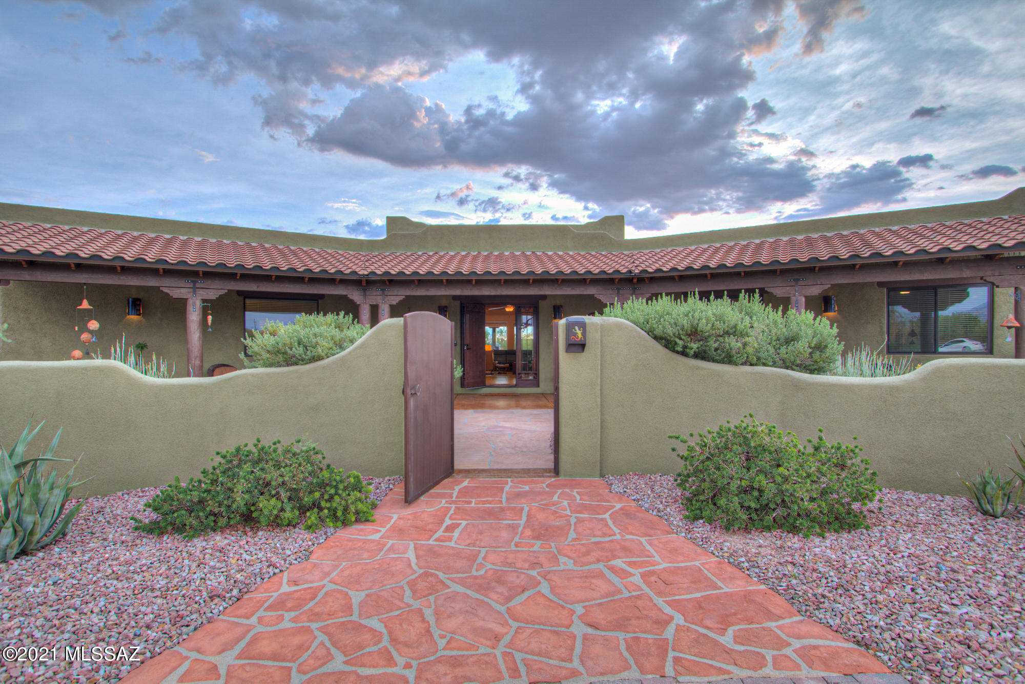 This Northwest treasure brings 3.31 acres of tranquil desert to life with a magnificent southwest  masonry block custom home. You'll know it is one of a kind as soon as you pull into the driveway, greeted by the desert's natural beauty and entry courtyard.  You'll find there is no lack of space here, both inside and out. The massive great room boasts raised wood ceilings and is open to the spacious kitchen and dining area. Master suite is unforgettable with a romantic beehive fireplace, large walk-in closet, and a tub with a view.  Larger bedrooms w/ walk in closets, a media room, and an office; all of this comes with a highly desired 3 car garage. This horse property has been meticulously maintained and offers you a clean slate to make it all your own, with a $25,000 yard allowance at closing. Call it home, today!