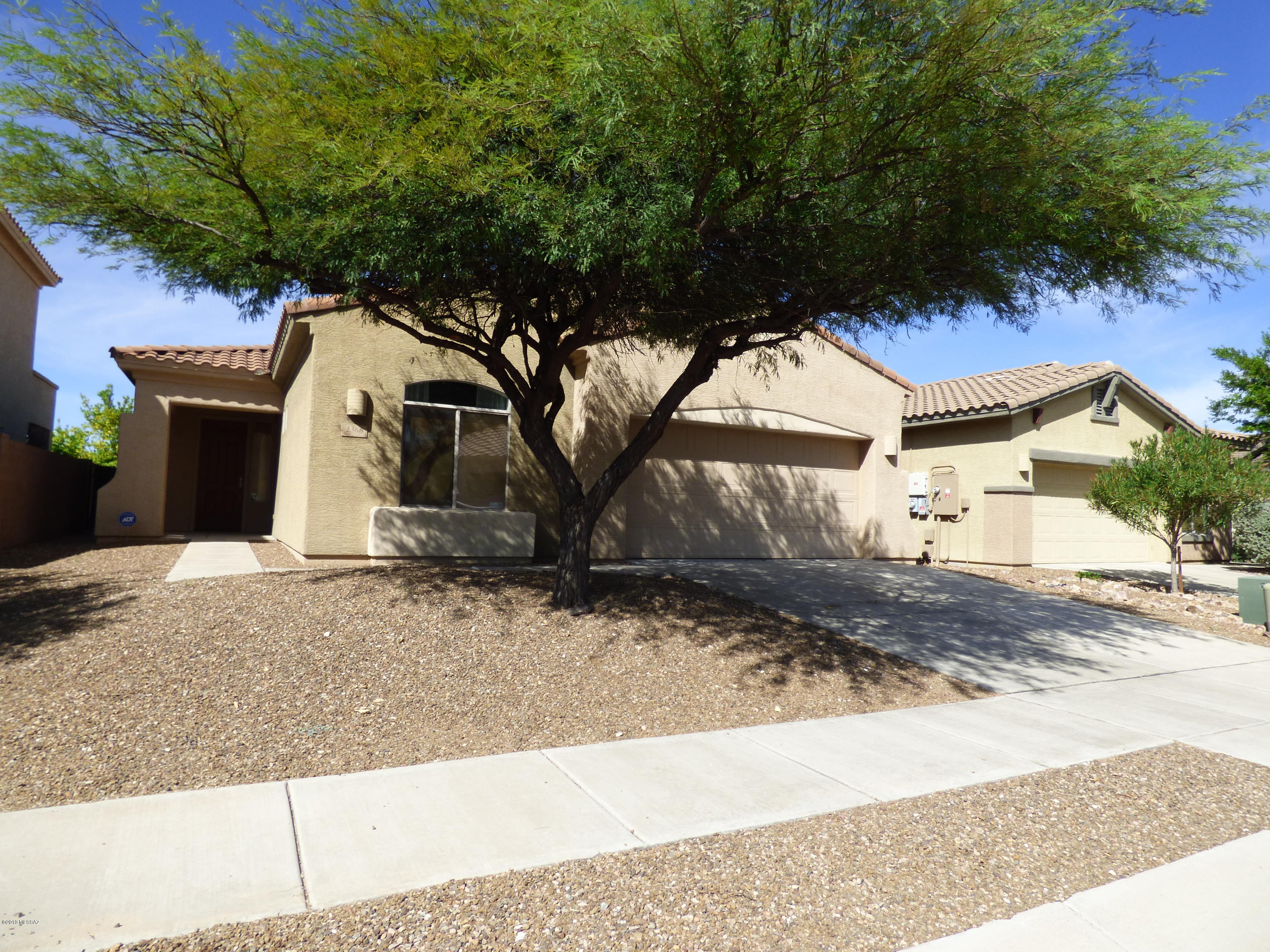 This lovely open floor plan home is move in ready. Fresh interior paint, newer carpet, wood blinds and ceiling fans throughout. Huge kitchen island and a den/dining room off of kitchen and great room. Split bedroom plan with a  3 car tandem garage. 2 homes away from the large, grassy, neighborhood park with playground and sports court.  Large laundry room will accept either gas or electric dryer. Plumbing in place for laundry room sink. West facing backyard has artificial grass and an extended brick patio.  Come see it! It won't last long.   Seller and seller's agent are related