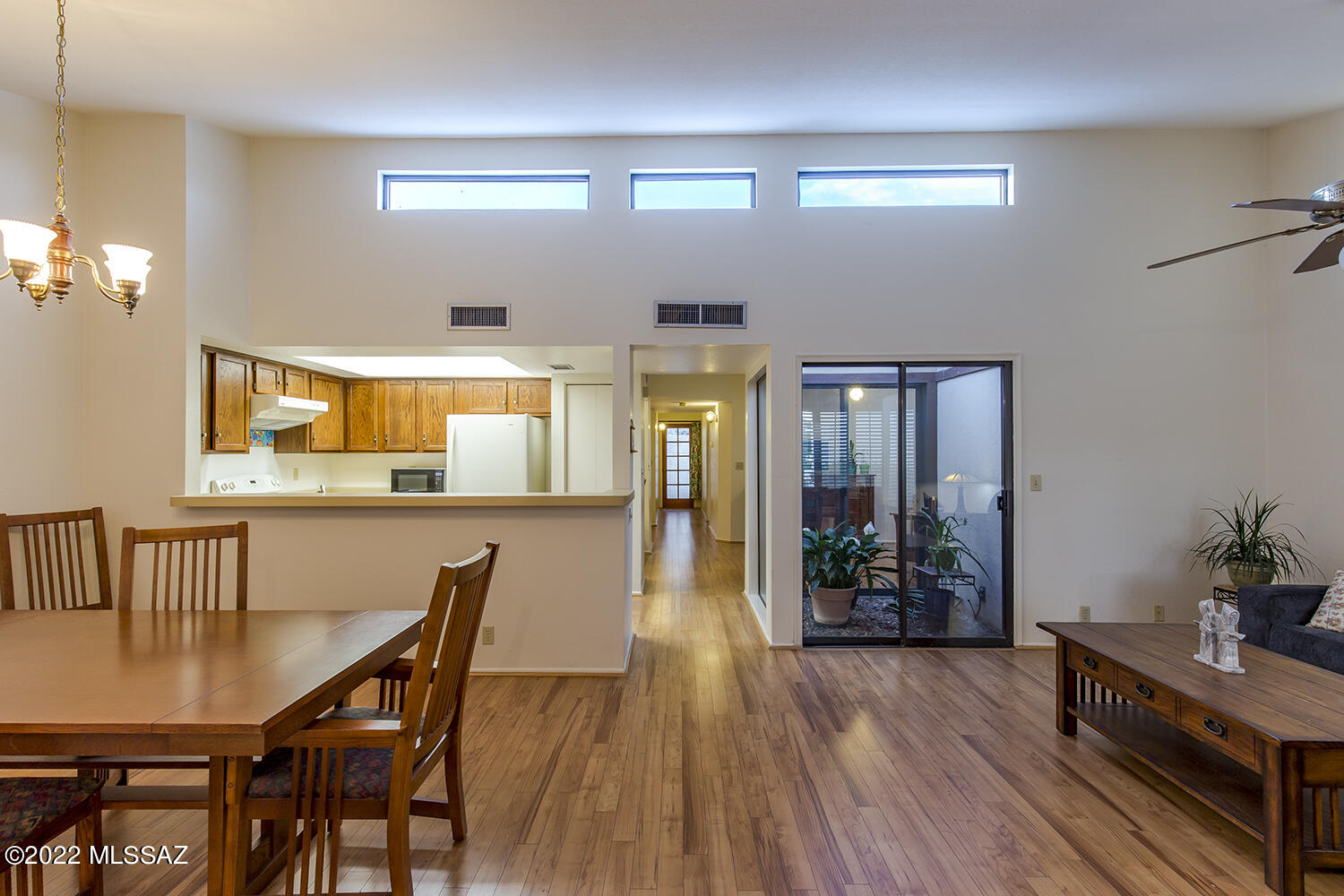 This smart Sabino Canyon townhome is tidy and move-in ready. 2 Beds/2 Baths. The large Living/Dining room has vaulted ceilings and is filled with natural light from clerestory windows, and a small solarium. The separate Den could be used as an office or family/TV room or converted to a 3rd bedroom. Newer bath and shower surrounds with glass panes on the shower. Laminate flooring throughout most of the home is over the same tile as in the baths. Carpeted bedrooms. Patio is accessed by a French door, as well as sliding doors off the owner's suite. Community Pool and Hot Tub. Less than a mile to the Sabino Canyon Recreation Area. Call your agent for an appointment today!