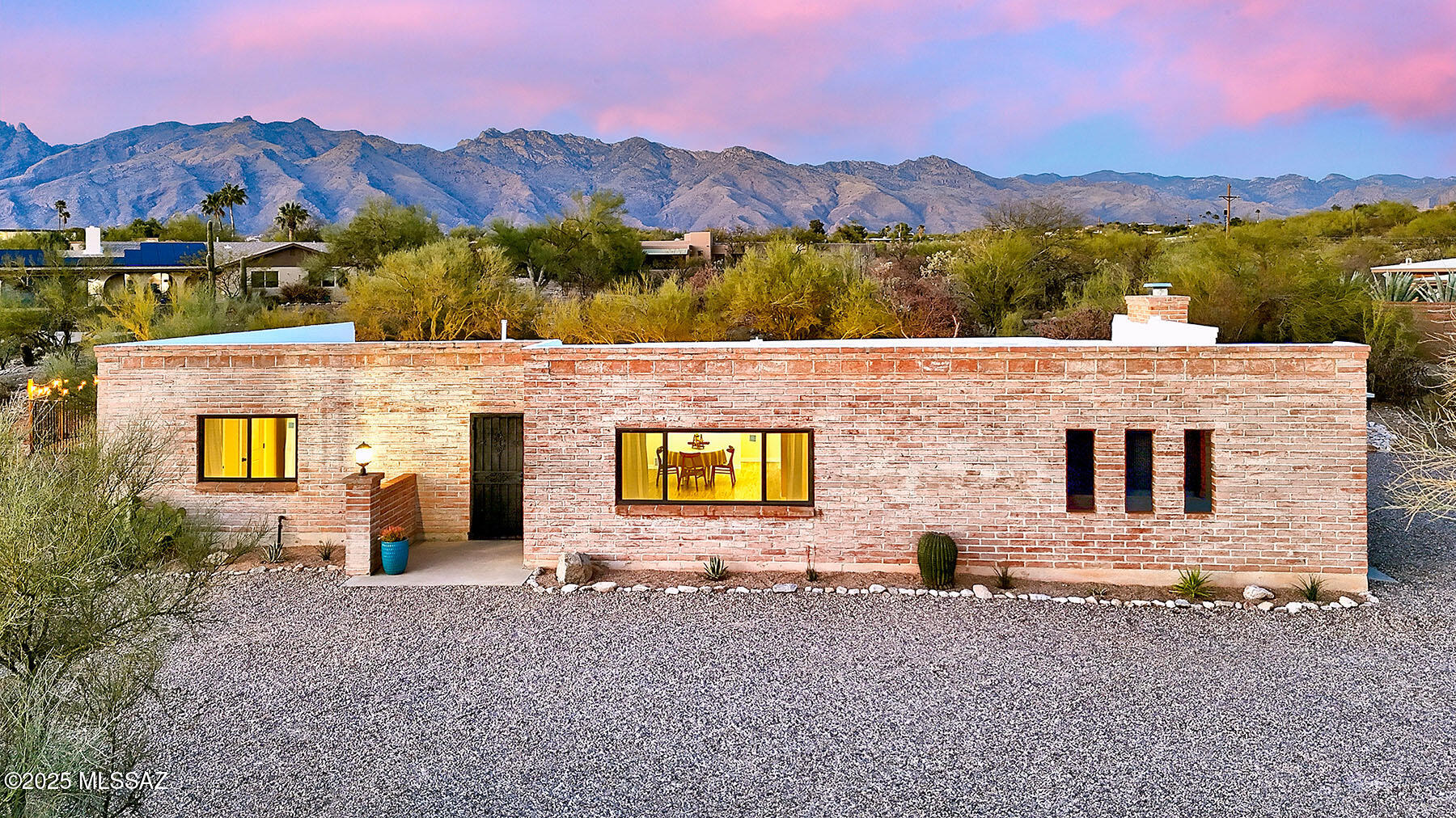 The perfect blend of a territorial burnt adobe home with fresh, modern updates!  This four bedroom home is secluded on over 1.6 acres, surrounded by desert landscaping including a dozen saguaros.  The open floor plan has a spacious living room, dining room & large kitchen open to a family room with wood burning fireplace. The gourmet kitchen is a chef's dream, with recessed and pendant lighting, high-end wood cabinetry, custom hood vent, open shelving, new GE appliances, 9' island with a breakfast bar, quartz countertops, and a full wall of tile backsplash.  And if that's not enough - the extra large laundry room offers more cabinets & butcher block counter for a butler pantry or craft space!
The extra large master bedroom features a large walk through closet, double vanity and large spa shower with lighted niches.  The three other bedrooms are spacious with plenty of storage.  Guest bathroom with double vanity and shower/tub features classic subway tile and wainscotting.  The exposed burnt adobe block interior walls provide character and texture and are complimented with custom paint scheme.
Outside the north facing porch is always shaded and provides relaxing views of the desert landscape & mountains.  Pool completely refinished and roof replaced in 2025.  It's all new - windows & sliding door, interior doors, interior & exterior paint, kitchen & bathroom cabinets, waterproof flooring.  This home truly has it all and is sure to impress!  Owner/Agent