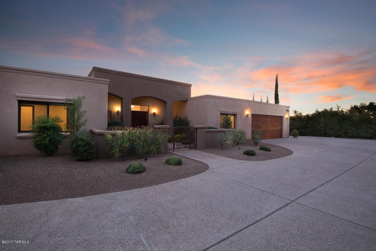 Luxurious hilltop living in the desirable Skyline Country Club Estates! Exemplifying the peaceful Arizona lifestyle & highlighting captivating city lights & soaring Mountain Views this custom 4bd/3ba contemporary in the Catalina Foothills offers excellent craftsmanship & design. Dreamy Chef’s kitchen equipped w/Granite counters, Cherry cabinetry, 5 burner gas range w/custom stone surround, Bosch SS appliances, cabinet panel dishwasher, & large farmhouse sink. Well-appointed Master suite boasts jetted tub, separate shower encased in natural stone, & access to the covered back patio. Mature vegetation, built-in gas BBQ, landscape lighting, & shaded seating in the pergola makes this professionally landscaped backyard perfect for entertaining guests or relaxing after finishing the back nine!