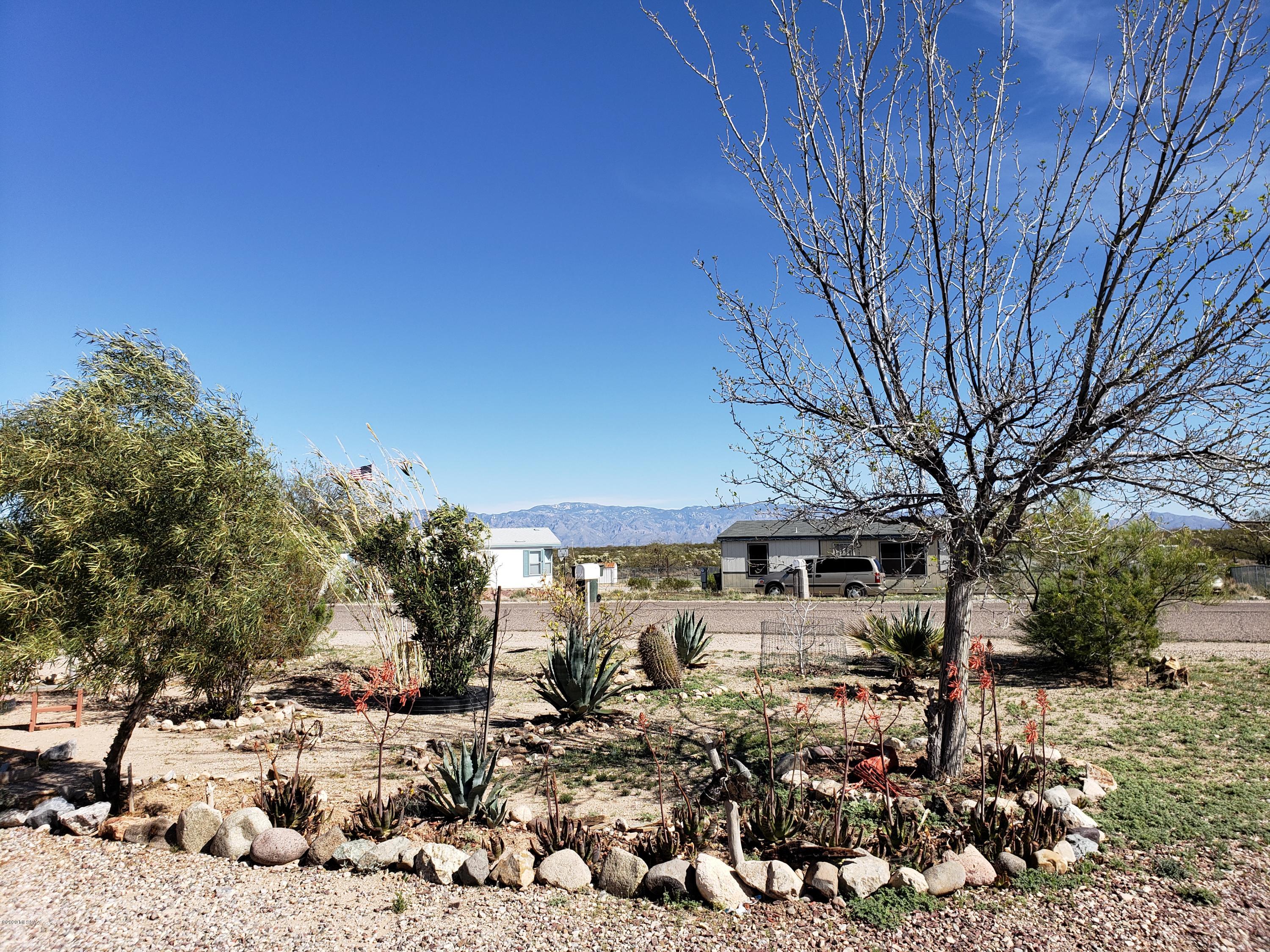 Situated in South East Tucson this is a dream home for anyone who likes a lot of space and a large yard. There is quick and easy access to the I-10 Freeway. As you pull up you will see views of the surrounding mountains and pull into a circular driveway with lots of parking. There is a large carpeted living room with a working wood fireplace. The master bedroom would fit a king-size bed and has a large tub/shower combo. All three rooms in the home have a walk-in closet. The center of the home is very open with a large dining room, and a bright kitchen. The stove is gas (great for home-cooks). There are also two full-sized refrigerators in the home! This home comes with a laundry room that has a full-sized washer and dryer.