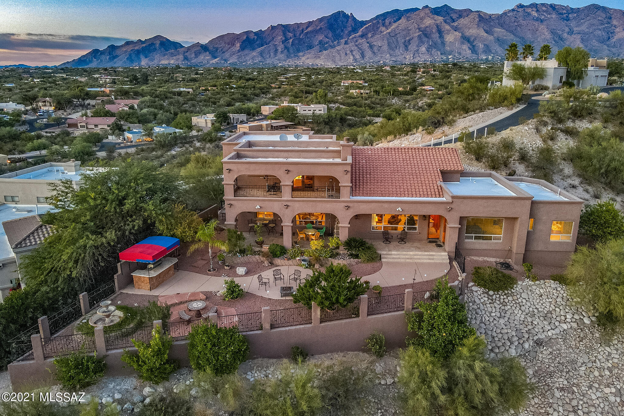 This fantastic foothills home sits high on hilltop with spectacular city and mountain views in gated community. You will be enthralled with unparalleled CITY VIEWS expanding the entire valley and dramatic views of both Catalina and Rincon Mountains. The vaulted ceilings, generous use of windows and open floor plan, convey an airy feeling. The open-flowing and sensible floor plan that lends itself to everyday living and large-scale entertaining is welcoming. Features include gourmet kitchen with granite countertops, gas cooktop, eat-in dinging nook and breakfast bar. The spacious master suite is on the ground floor for your convenience with soaking tub, his and hers walk-in closets and door to backyard. Other features include expansive view decks, gated front courtyard, decorative niches, central vac, North/South orientation, skylights, and many custom touches. The fabulous backyard with views galore, extensive patio, wonderful landscaping with variety of desert vegetation and fruit trees and extensive outdoor lighting, is entertainers' dream. Enjoy Tucson's most beautiful sunsets and star-studded night skies from your private backyard. The Rillito River trail which is great for biking, running and walking is a stones throw away, and Neighborhood has access to it through a gate.