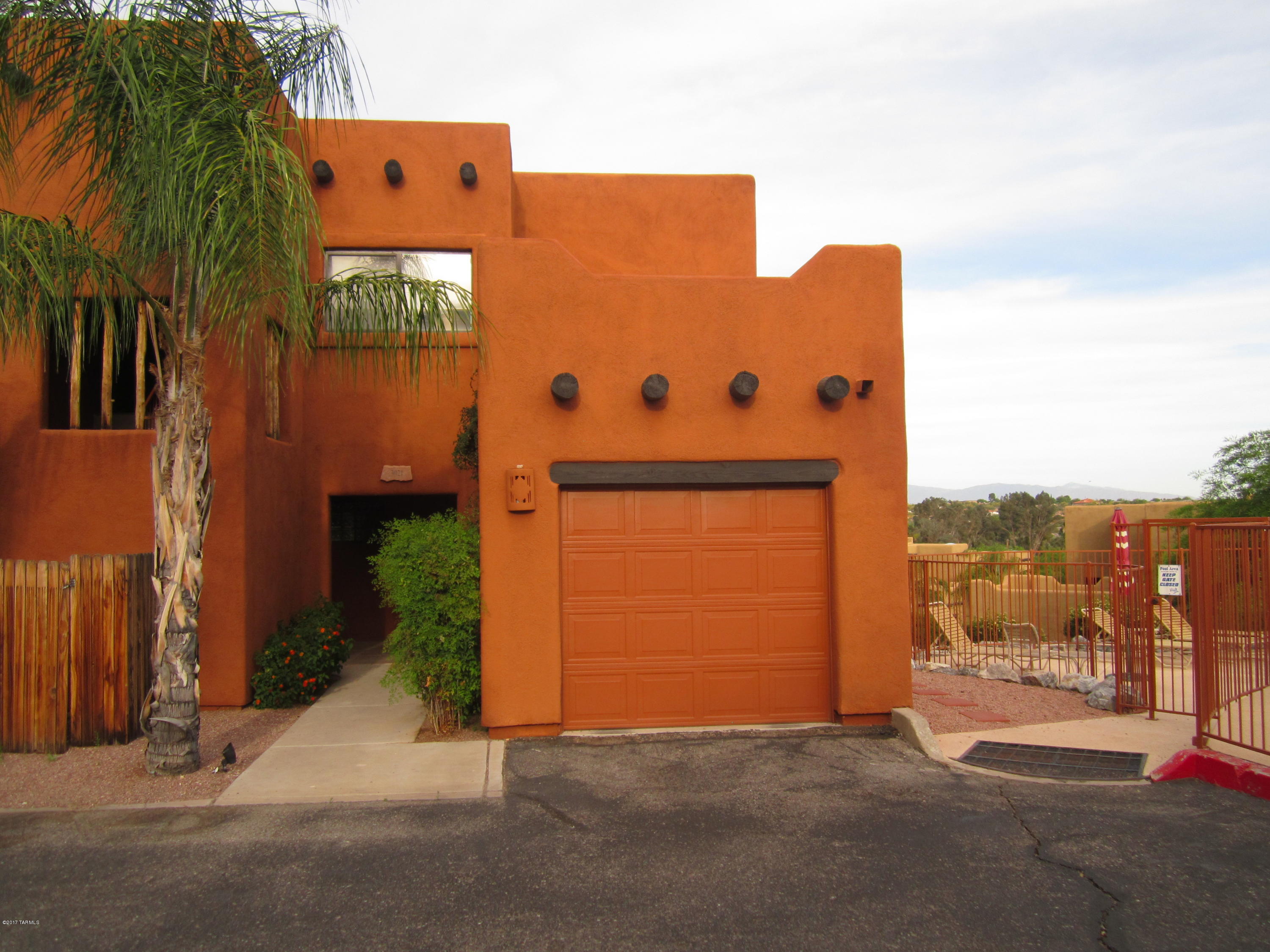 Santa Fe style condo that lives like a Townhome! Gorgeous Mountain views from great room, big contemporary kitchen, Split bedroom plan, Fireplace, One car garage, Community pool just footsteps away! Ground floor unit. Hard to beat in this price range! Beautiful and convenient part of town!