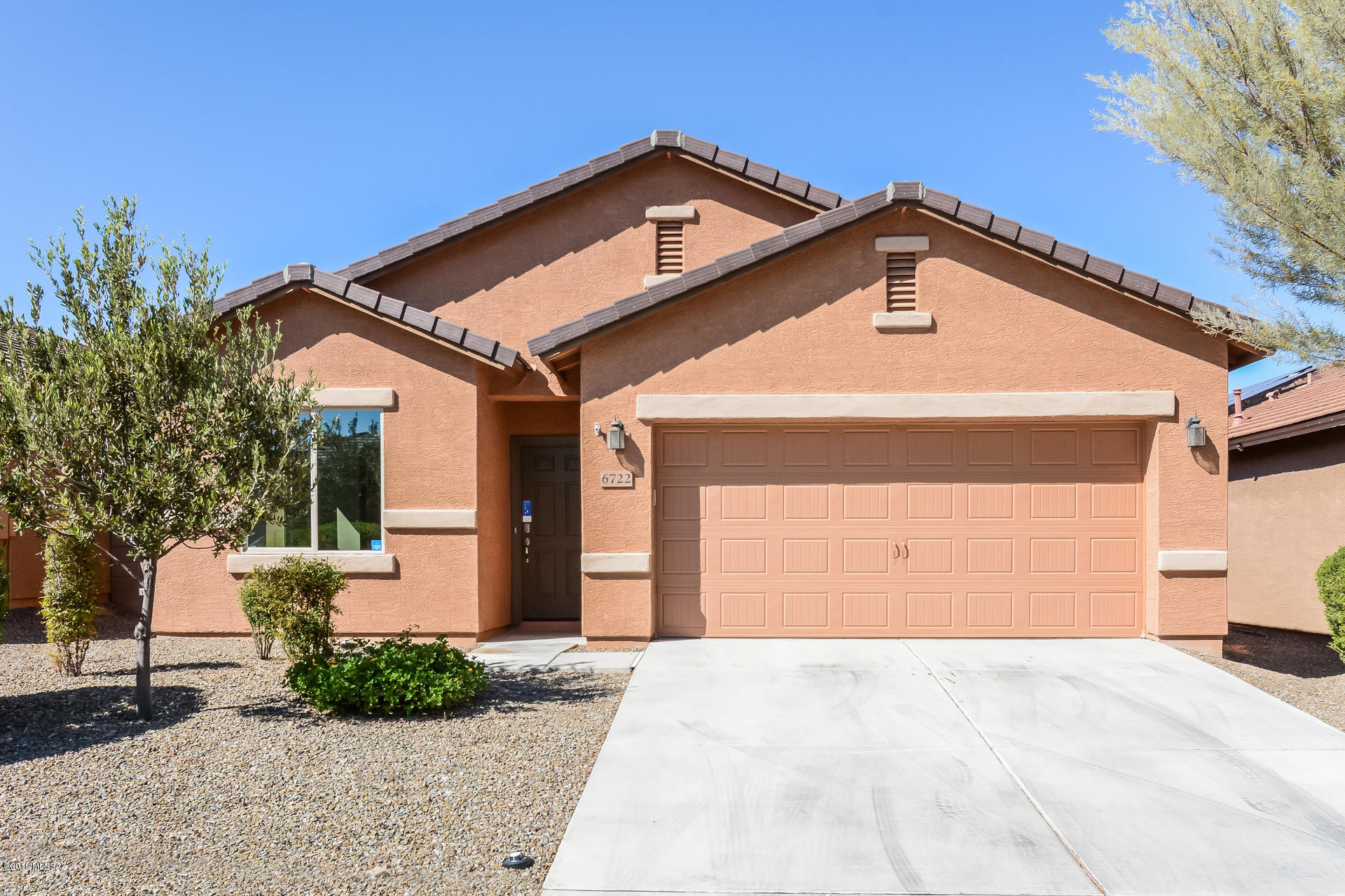 Built in 2014, this Tucson one-story offers granite kitchen countertops, a covered patio, and a two-car garage.
