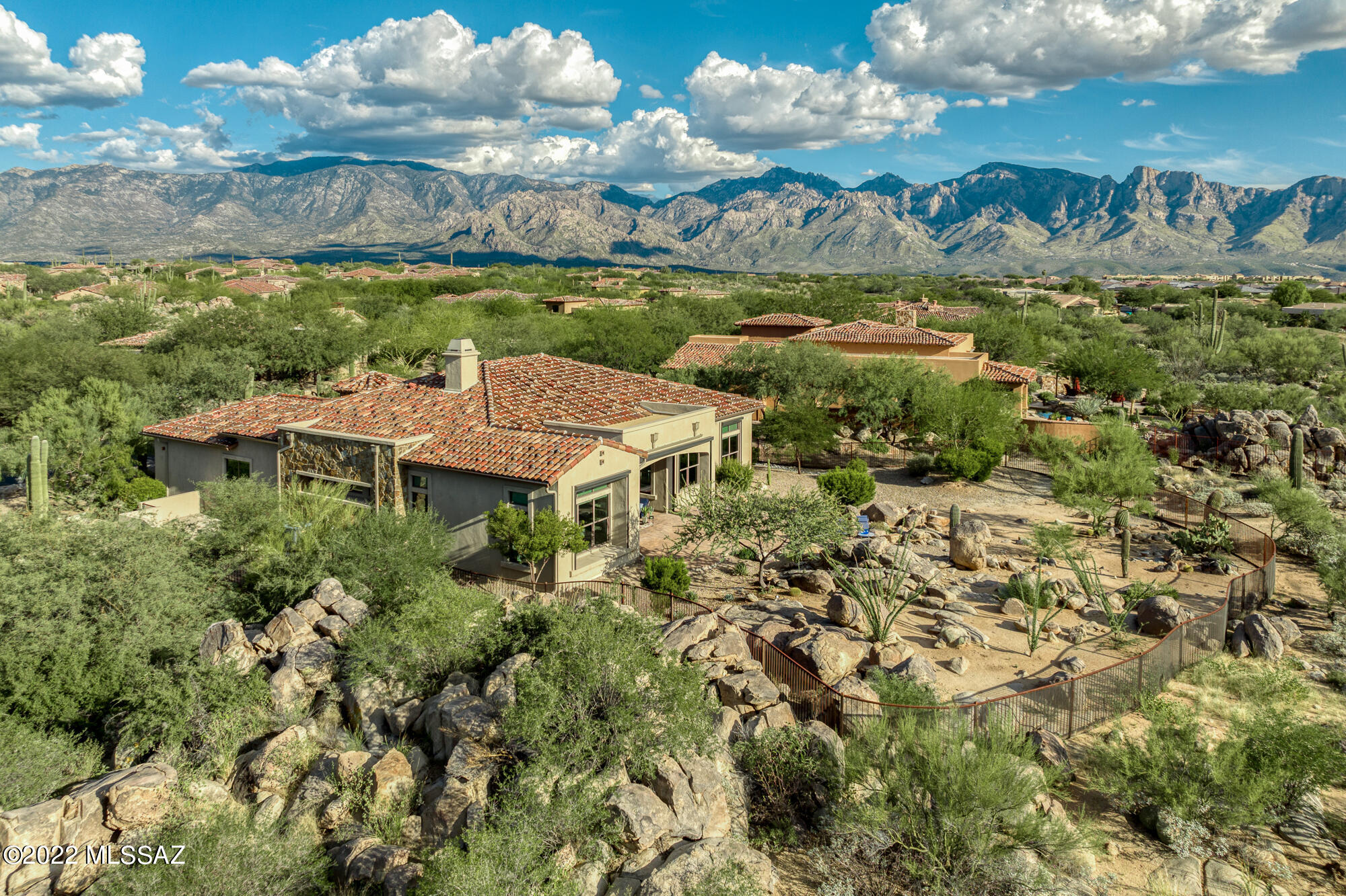 Pristine, serene, gorgeous! Energy efficient former model home: 2,888 SF, 3BR, 3BA, Den, 3-car tandem garage, private corner acre location. Luxurious guard-gated Stone Canyon Club retreat! Great room living area w/Isokern Fpl connects via multi-slide window wall to deep cov'd patio for entertainment enjoyment (generous seating, automated rolling screens, BBQ & TV). Chef's kitchen w/highly upgraded amenities (6-burner gas cooktop, soft/self-closing Bridgeport Maple Karman cabinets w/pullouts) plus formal & informal dining, coffered ceilings, tile floors. Stunning Master Suite w/patio access, spacious bath (dual vanity, makeup vanity, dual access shower), huge closet. Two large pantries plus laundry w/sink & window. Enjoy stunning rock outcroppings, desert landscape, mountain & sunset views!