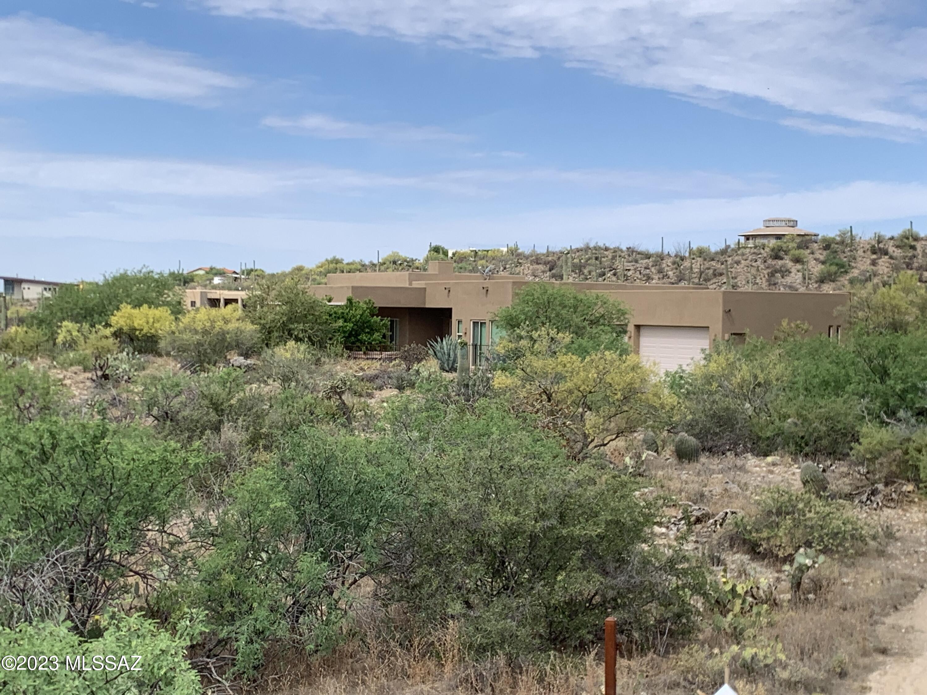 Custom high-end horse property in the Tortolita Mountains surrounded by lush Sonoran Desert for your own private oasis.  Windows throughout bring the outside into the home. Relax under the large covered patio & cool off in the pool among lush desert landscaping & rock outcroppings. City lights & Catalina Mountain views from this 5-acre gated property with access to miles of horse & hiking trails & NO HOA. Open Great Room & high ceilings throughout. Custom kitchen with large island, hickory wood cabinets, granite counters & high-end appliances. Master bedroom has walk-in shower, soaking tub and access to the patio and pool. Second bedroom with bath & walk-in closet. Professionally built 4 stall steel stable, horse arena, grain silo and lots of trailer & RV space. Oversized 3 car garage.