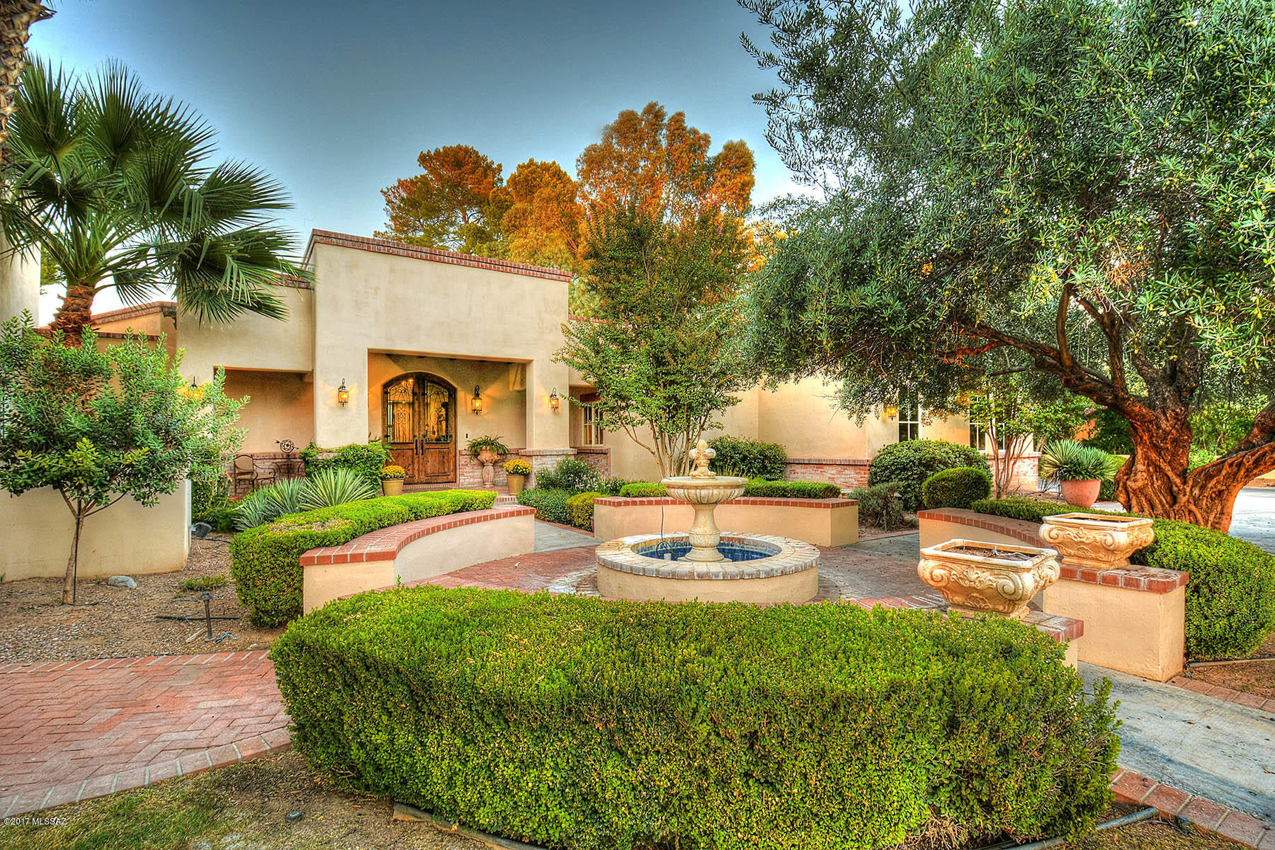 Enjoy incredible mountain views, privacy & casually elegant living on one of the very best lots in Tucson Country Club, featuring gleaming walnut flooring, beamed & lofted ceilings, sunny chef's kitchen, cozy family room, home movie theater, game room, choice of home offices, library loft, shady covered porches, outdoor kitchen, roof deck with glorious views of the golf course & Catalina Mountain range, private putting green, bocci ball & basketball court, charming full guest house, and so much more described on the Amenities list in the attached Documents. Did we mention the Seller is an interior designer? So, yes it's BEAUTIFUL!  A large extra home office & den can also serve as a 4th bedroom in the main house. Really exceptional! RARE FOR A LOT OF THIS QUALITY TO COME TO MARKET IN TCC!!