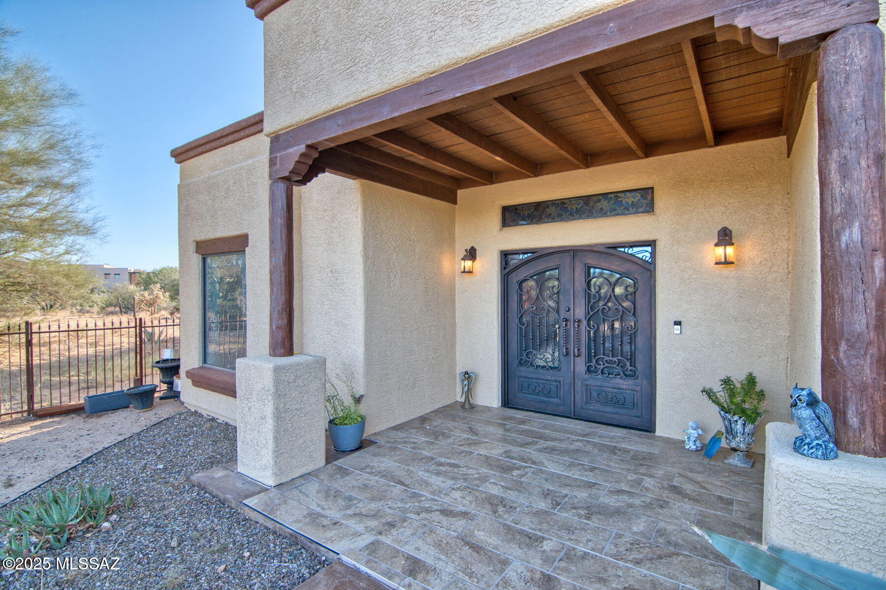 Experience serene desert living in this gorgeous home set on just over an acre, offering a rare blend of comfort, sustainability, and natural beauty. Enjoy the benefits of paid-for solar power and a spacious 3-car garage, perfect for all your vehicles and storage needs. The inviting interior features high ceilings throughout, complemented by elegant Italian tile and warm wood floors. Relax by the cozy gas fireplace in the living area, or savor clean, refreshing water with a reverse osmosis drinking system. The iron security front door adds peace of mind, while French doors open to a rear yard that frames panoramic mountain and desert views—an ideal spot to watch local wildlife in their natural habitat.The property is surrounded by rattlesnake-proof fencing for extra safety and peace of.. mind. Nestled in a tranquil setting near Kitt Peak National Observatory, this home offers the perfect escape with every modern comfort. Discover unmatched privacy and breathtaking vistas in a home designed for relaxation and connection with nature.