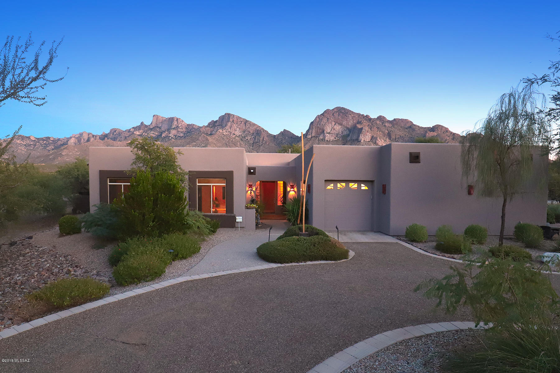 Don't miss this home!  If you like to entertain, you will love it.  Inside you will find 12' ceilings with a wide open great-room, travertine tile, gas FP, & an exciting 10' wet-bar. It's perfect for hosting simple or elegant get-togethers.  It's distinctly unique and known by the OVCC community as being located on 'Millionaire's Row'. The 1.5 acres of lush and mature gardens are on one of the largest lots in the area. There's a new custom-built pebble tec pool with 3 flowing waterfalls and a cozy lagoon for lounging. The sparkling pool and majestic mountains are easily seen from the adjacent double-sided covered porch. The kitchen has Granite Countertops, a 6 burner Gas Cooktop,  and an Island with a farm sink.  There are 2 full baths and a very elegant powder room. Other exciting features are a huge Master Walk in Shower and a walk in Master Closet.  Outside under the covered porch you will find a built-in beehive FP, built-in Ref. and a TV.  The 4 car garage has even more STORAGE plus a workman's bench.  DON'T MISS THIS HOME - OPEN SAT's & SUN's - check MLS #21729868 for times.