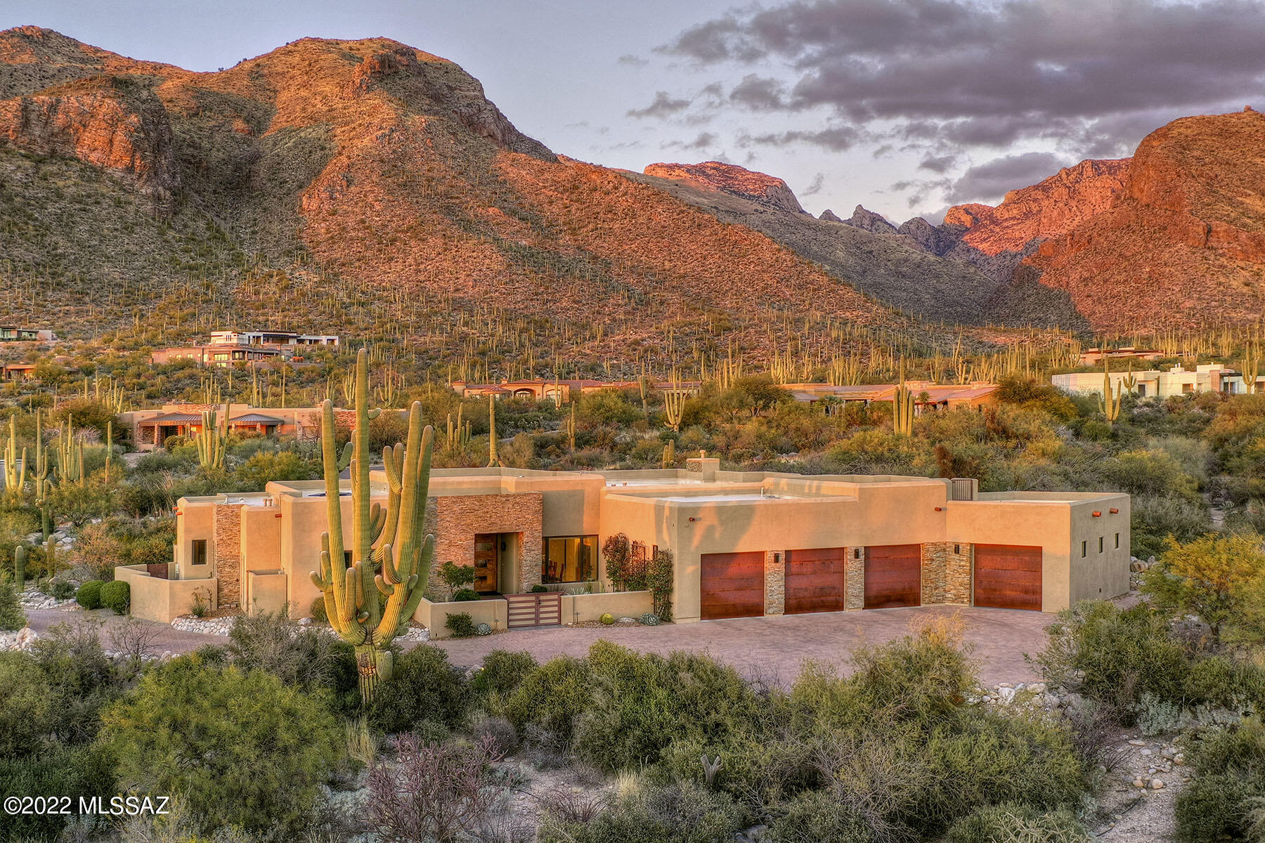 Perfectly situated in Pima Canyon Estates ''Gardens'' & tucked w/i the exclusive back upper gated section, this contemporary is the perfect balance of elegance & sophistication. Exuding privacy & exceptional Catalina Mtn views, entertain in resort-like backyard w/ a built-in outdoor kitchen, solar heated pool/spa, elevated firepit & versatile spaces for your heart's desire. This home is about attention to detail, craftsmanship, quality & luxury. Features: Observation roof deck w/ stunning city views, indoor/outdoor sliding doors, open floorplan, expansive chef's kitchen w/ Wolf appliance pkg, spa-like master suite, exquisite architectural accents, 4th bay garage w/ upgraded electric, ensuite bdrms/bonus rooms, high ceilings – natural light, no steps & timeless, warm color hues throughout