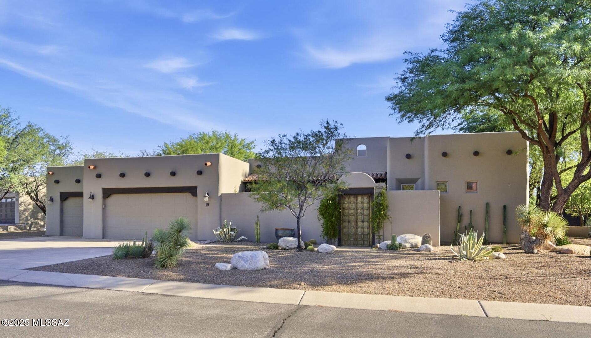 Enter this lovely home through the unique round foyer into a bright, airy, open Hacienda model floor plan.  This well-maintained home has a total of 2,531 Sq. ft and features 2 bedrooms (one in the separate 405 sq. ft. casita) and 2 ½ baths.   This stylish home has one primary bedroom and  full bath, large den, open concept kitchen with updated stainless steel appliances, new tile back splash and quartz counters. 
This living room has a wood beamed ceiling and and a gas fireplace. The room opens to the front and rear patios for easy entertaining.
The casita which has its own private entrance for ease of use offers your guests comfortable accommodations with a bedroom and full bath. 
The front courtyard features a wood burning fireplace and fountain. While the rear covered patio overlooks a beautiful heated pool and spa surrounded by lush, mature desert plantings. 
Additional features include: three car garage, water softener, central vacuum system, and tiled flooring throughout the home. 
A stairway to the roof offers the potential for a roof deck, perfect for enjoying views of golden sunrises and sunsets or Arizona 's renowned star gazing.
Embrace the best of Southern Arizona lifestyle in a beautifully landscaped setting.
