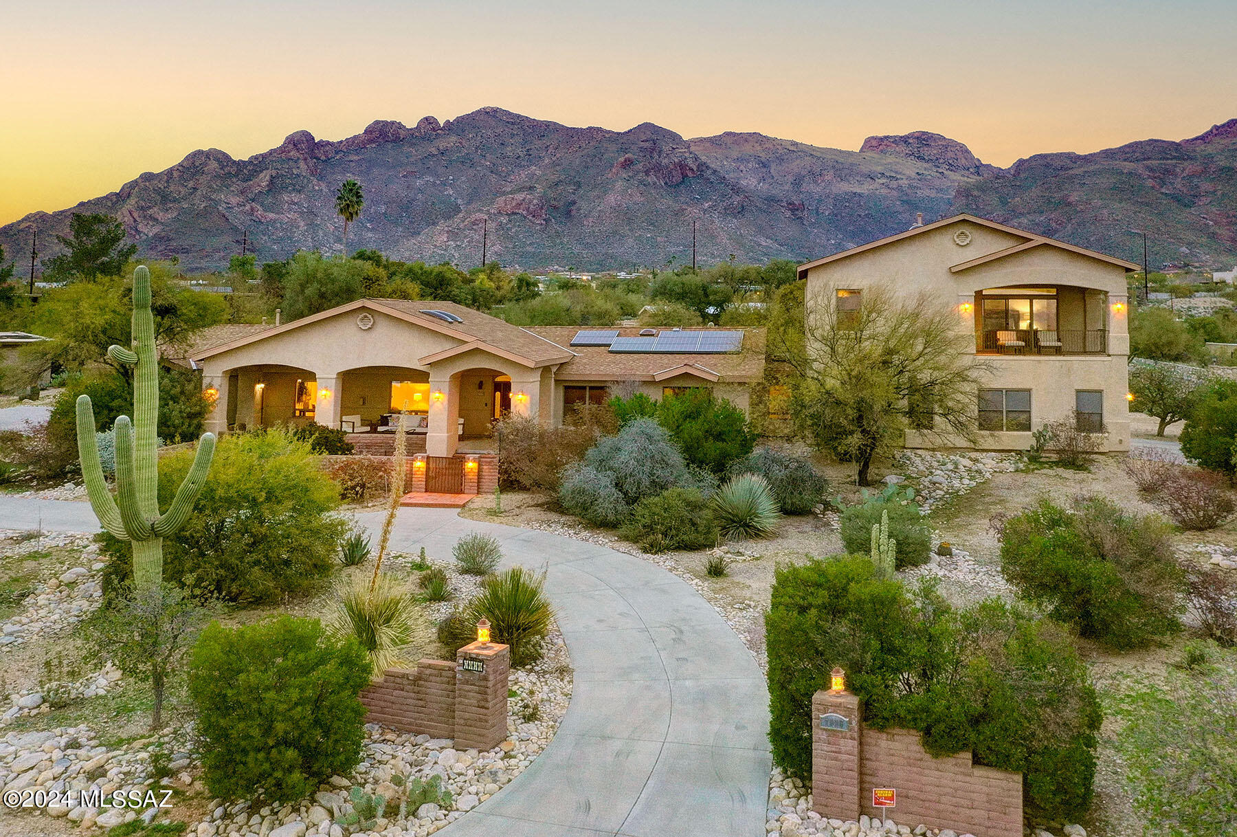 This outstanding 2006 (originally built in 1970-effective age 2006) Mediterranean contemporary is on a 0.97-acre lot in the Catalina Foothills and offers magnificent city and mountain views. Highlights of the 4,153 sq. ft. residence include a circular driveway, a spacious living room with 20'' Italian porcelain flooring & a grand fireplace, cherry wood cabinetry, 4 bedrooms plus an exercise room & a den/office, 3.5 bathrooms, and a generous laundry room with sink/desk/storage/folding table. The fabulous gourmet kitchen provides granite counters & backsplash, stainless steel appliances including a warming drawer, and an oversized kitchen island with designer features. The gracious upstairs primary suite offers Brazilian cherry wood flooring, a balcony framing spectacular city views, 2 oversized walk-in closets with built-ins, and a luxurious bathroom complete with dual vanities, granite counters, a garden tub & a separate shower.  Additional features includes garage parking for five cars with a sink & EV charging system and an owned solar system. Enjoy the beautiful outdoor living areas offering 2 expansive porches, a professionally landscaped rear yard with pool and sweeping views. District #16 Schools.