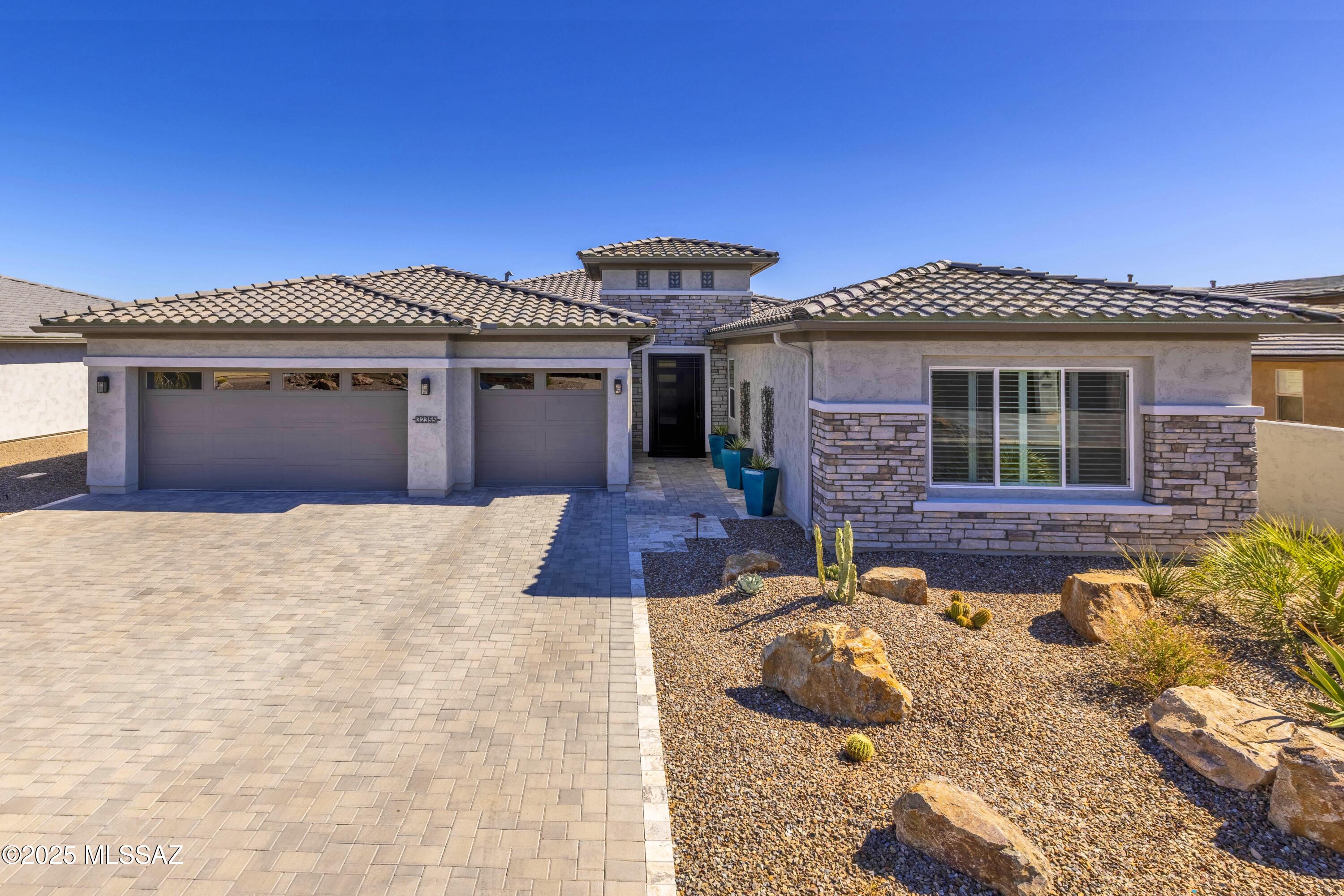 A Highly Upgraded 2466 Sq. Ft. Vienta Exterior Design A Pool home located on the 15th-hole in the 55+ Active Lifestyle Community of SaddleBrooke Ranch.  The home consists of 3-Bedroom En-Suites ( Optional Bedroom 3 Suite); Powder Room; Great Room w/Media Alcove; Dining Area; Entertainer's Kitchen Island; Walk-In Pantry; Spacious Den; Master Suite w/Generous Walk-In Closet and 42'' X 60'' Shower and Built-In Seat; Bedrooms 2 & 3 have Walk-In Closets; Owner's Entry Valey w/Cabinets; Walk Up Dry Bar; Large Laundry Room; Deep 3-Car Garage w/Extra Storage; 378 Sq. Ft. of Covered Outdoor Living Space; 9',10', and 11'' Ceilings throughout the home.  Other structural changes include 4-foot extension on 3-Car Garage and Optional Bedroom 3 Suite. The home has been professionally decorated w/Custom Built-ins; Window Coverings; Tiled Walls, Custom Artwork; and exquisitely furnished of which most of these furnishings can be purchase by the buyers, including the golf cart. Location, location, location, as this home is ideally situated on the 15th hole with incredible Golf Course & Catalina Mountain views while floating the luxurious pool in the backyard. 
The custom designed pebble-tec laden pool and spa is surrounded by a travertine deck that extends over to the fire pit area where there is an installed gas fire pit, ready those cool evenings enjoying your backyard!
