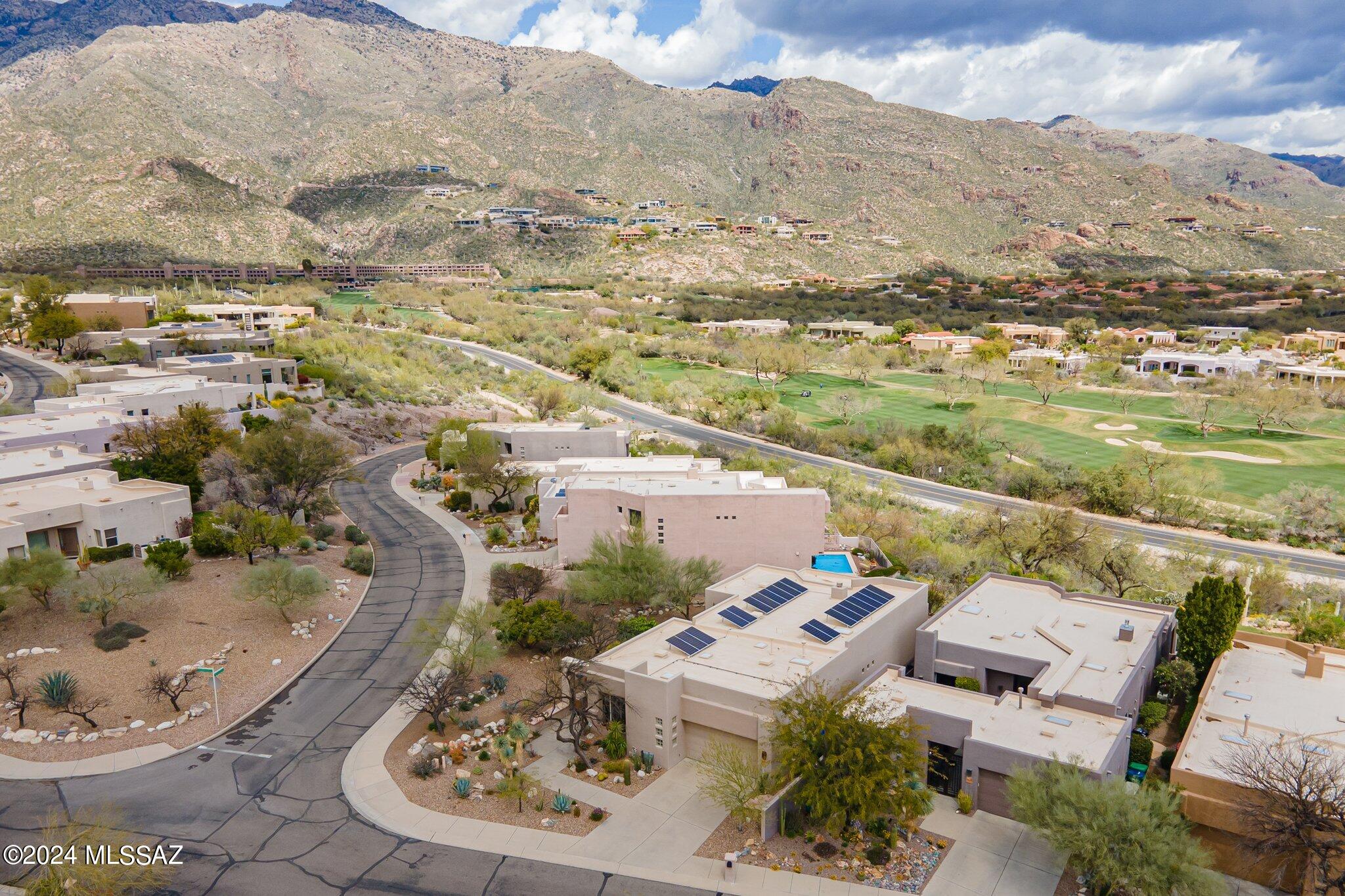 Elegantly Updated, One Level, 3BR & 3BA, Masonry Built Home in Highly Coveted 'The Ridge at Ventana Canyon' w/ Panoramic Valley & Mountain Views! Fine Features Include: Courtyard Entry - Custom Front Door w/Philabaum Glass - Travertine Floors + Solid Wood Doors Throughout - Great Room w/Fireplace Opening to both a Formal Dining Area w/Catalina Mountain Views and Kitchen w/Custom Cabinets, Granite Counters, Stainless GE Monogram Appliances & Breakfast Nook - Primary Suite w/Sitting Area,Views & Spa Like Bath w/Walk In Shower - Spacious Guest En Suite, 3rd BR/Office w/ Custom Built In's - Solar Panels (Owned) - Windows w/Automatic Shade Screens - Epoxy Garage Floor - Private Outdoor Living w/Covered Patio, Built In Grill, Pool + Spa, & Panoramic Valley & Mountain Views!!
