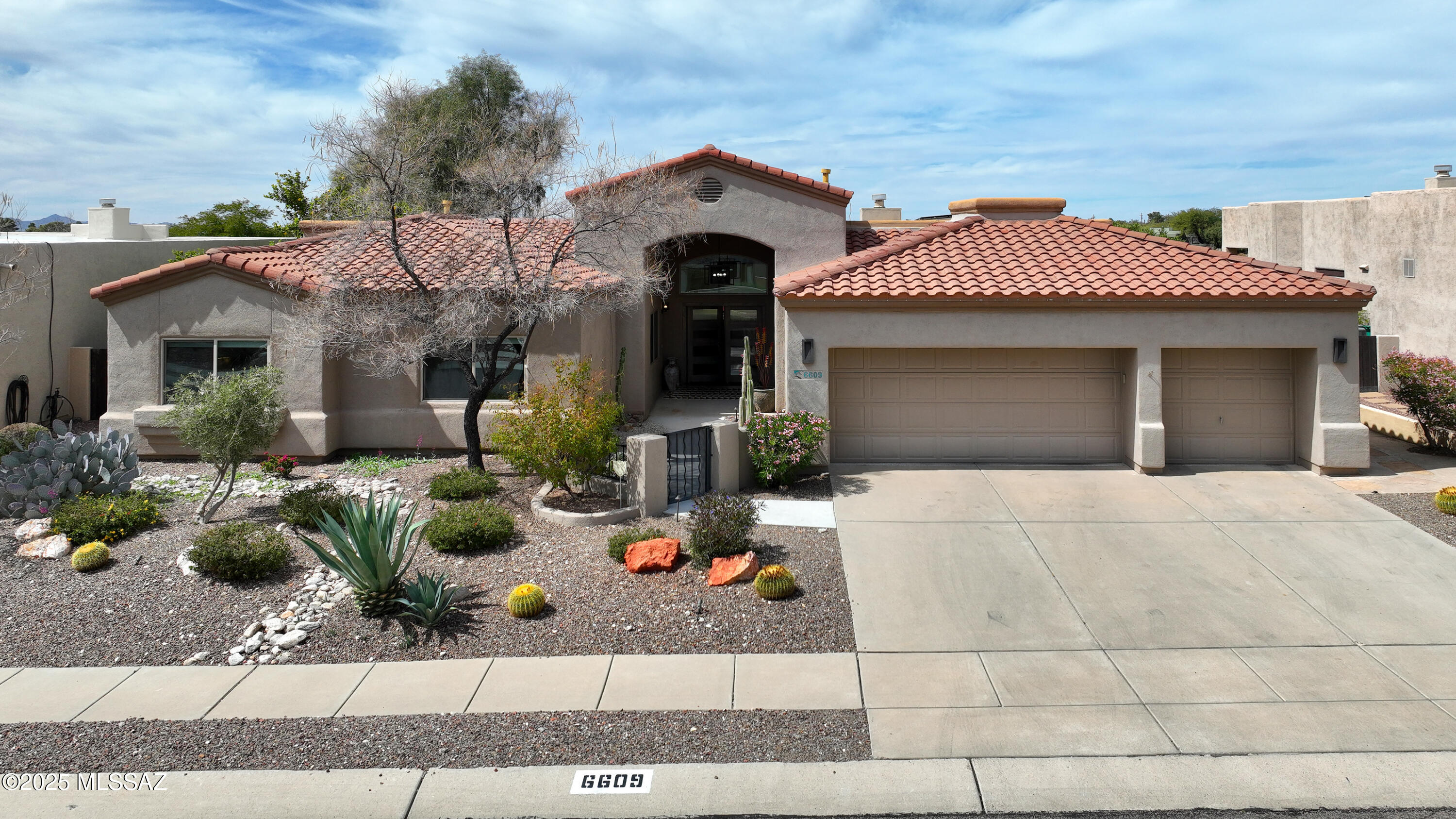 Simply stunning must see Contemporary home in Shadow View estates. Every aspect of this home has been renovated with exquisite taste & the finest of details. 4 bed 2.5 bath with den. Enter from the elegant front courtyard & foyer to the high ceilings & huge view windows of the living area. Tastefully installed ceramic tile. Beautiful custom built grey & white kitchen cabinets accented with smokey grey quartz countertops. This gorgeous space opens to a spacious family room with corner windows with views of the Tucson Mts. Enter your sweeping primary suite with sitting area & bath with extra wide walk-in shower, sleek cherry wood double sink vanity. Walk-in closet with all the options for organizing your wardrobe.  3 bay garage with EV port, zoned  HVAC with humidifiers, owned solar system. Electric remote controlled shades on large view windows. Kitchen cabinets have pull out drawers and soft close features. Wolf gas cooktop. Wall mounted oven and microwave. All lighting, fans, fixtures outlets and switches replaced in 2017. Both HVAC units replaced in 2017. Full house water filtration with salt free softener, electric outdoor solar shades on porch, rolling security shades on south and west side. Landscape lighting. Citrus trees- grapefruit & Oranges. The quality and exquisite design of this home is not often found. Come take a look before it is gone.