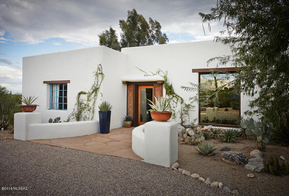 1936 Joesler Situated on nearly 2 private acres in prime Old Foothills with gorgeous mountain views. All elements of its original charm remain intact, from huge picture windows framing Catalina mountains to rustic beamed ceilings & 12'' thick adobe walls. Original design has been augmented by a tasteful renovation of kitchen, master suite, & guest house. Wonderful outdoor living spaces, including charming outdoor kitchen w/fireplace & built-in grill. Beautifully landscaped with native old trees and a dash of fruit trees including pomegranite, citrus and loquat , plus a wonderful fenced garden area. New Nest three-zone HVAC. A must see for fans of wonderful old Tucson style. Prime location.