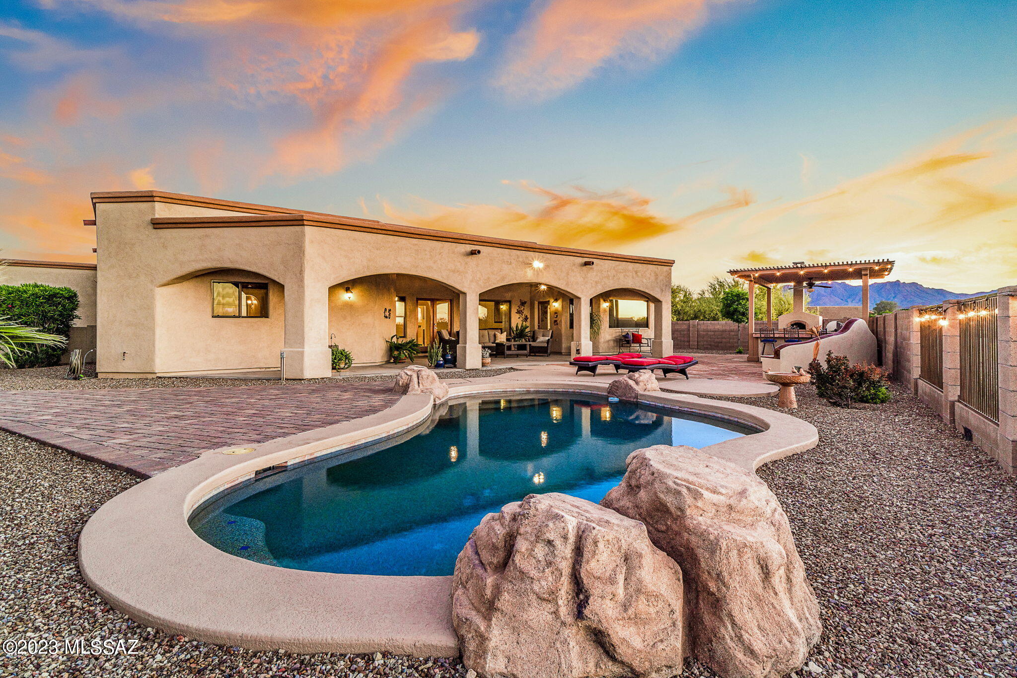 This beautiful owner's pride, semi-custom home sits perfectly on a 1.16-acre lot in the desired Sunset View Estates, a subdivision with only 50 homes.  Relax and enjoy the picturesque Tucson Mountains and their stunning sunsets while grilling or baking a pizza and cooling down in the sparkling pool.  Yes!! You heard right, a wood burning pizza oven and charcoal grill in the gazebo ready to entertain your guest!  The interior of this GEM also features a split floor plan, granite counter tops, newer stainless steal appliances, water purification - RO System, a cozy fireplace, ceiling fans, ceramic and wood flooring.  A MUST SEE!!!