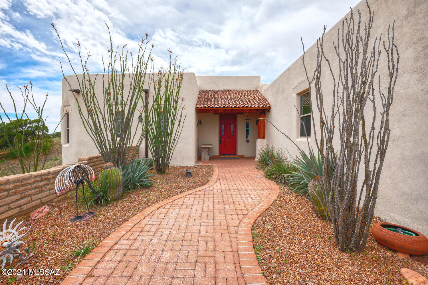 Exquisite custom adobe home with old world craftmanship and modern amenities.   Panoramic views of mountains and oak-studded grasslands. Elegant 3674 sf, mud adobe, 3Bd/2.5 Ba with separate office, attached  bonus room /workshop with epoxy floor, & custom cabinets.  Open, split bedroom floor plan with massive beams, vigas, bamboo or wood cellings and beehive fireplace. Imperial plaster walls and Saltillio tile floors (except  Bonus Room). Kitchen remodeled in 2016 with Hickory cabinets, hand-forged bronze hardware, &  Wolf, Bosch & Sub-Zero appliances.  12x24 Storage shed.  Inviting covered patio perfect for enjoying the sunsets. Four fenced patio/yard areas. New windows in 2023 w/double lifetime warranty.  Room for horses. Property borders the magnificent Babacomari Ranch