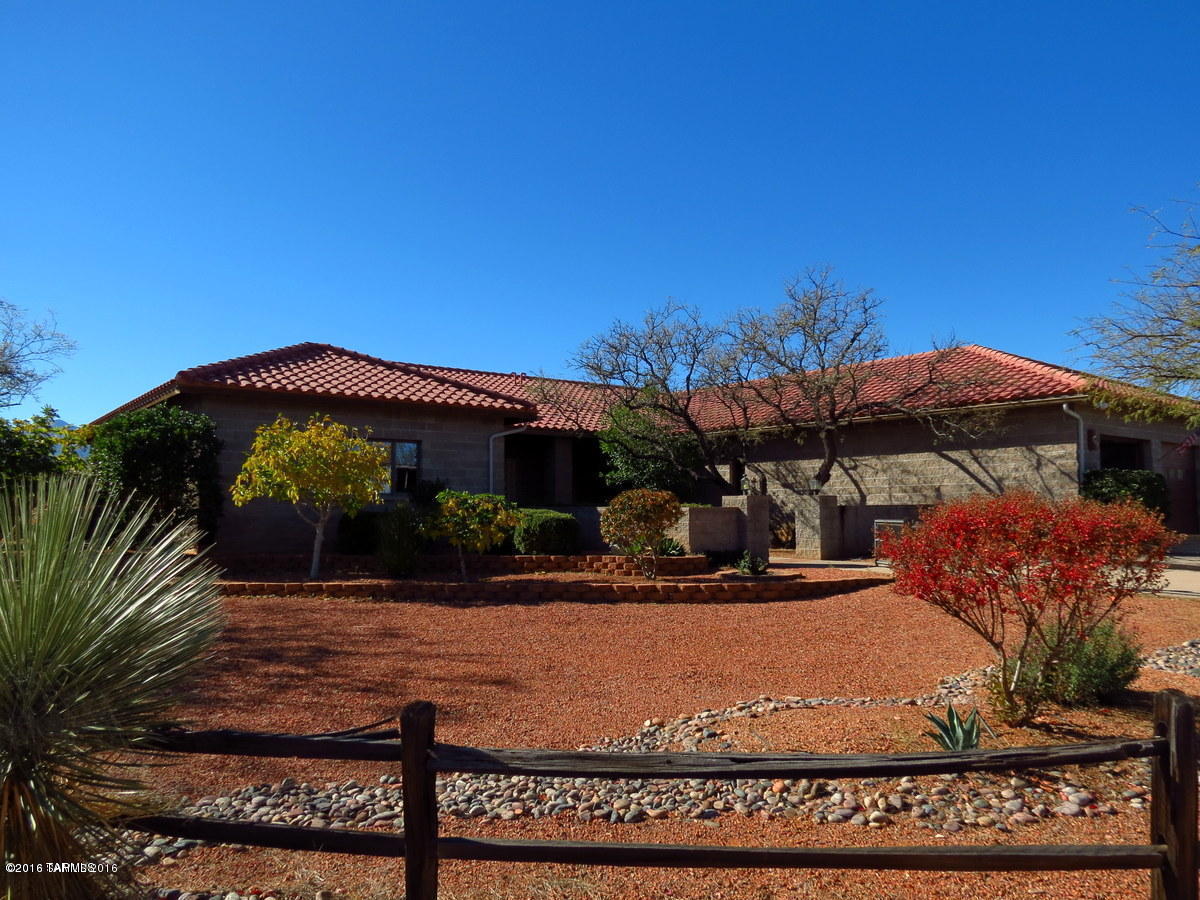 Country living in the city! Custom home on 4.77 acres in the heart of Sierra Vista! Only minutes from Fry Blvd. and Hwy 92. Fabulous mountain views with a well designed wrap-around covered and uncovered patio for entertaining. Exceptional block and cement construction with 3 bedrooms, 2.5 baths, oversized garage, custom kitchen cabinets with pullout shelving, granite countertops, Anderson windows and patio doors throughout. Split floor plan with gorgeous, open, living/dining/kitchen area. Large master bedroom with large well designed walk-in closet. Another huge bedroom or great office with private access. Completely fenced with electric front gate & paved circle drive. Horses welcome (up to 6) with horse/animal pen. Contact listing agent for more amenities or to schedule private showing!
