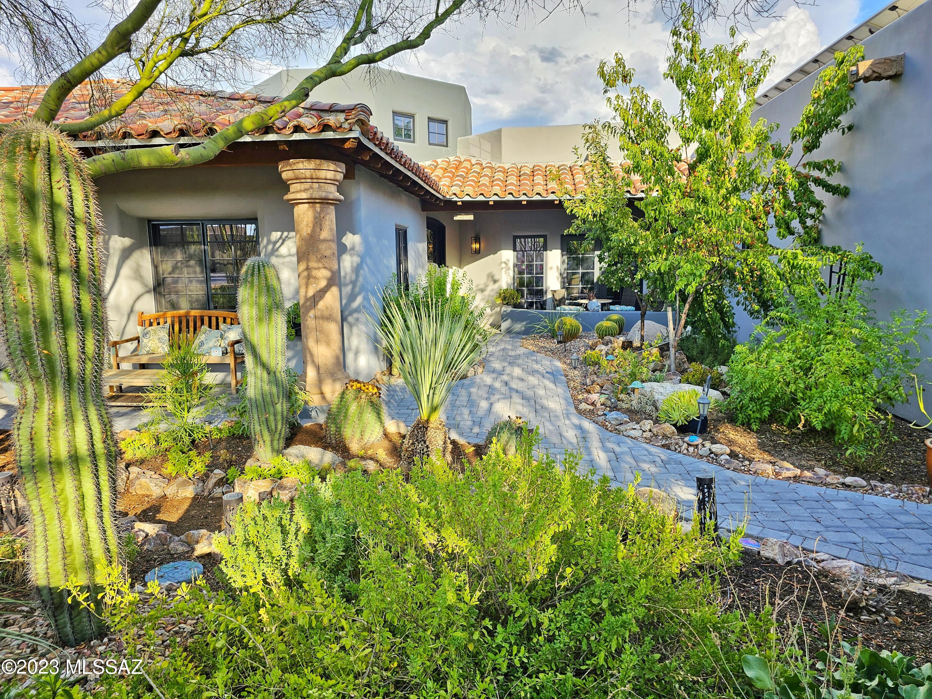 This stunning custom home is where the Mediterranean meets the Southwest. It is situated on a premium lot with mountain views in the highly desirable Ironwood Canyon gated community. This property boasts 5 bedrooms plus a loft, a theater room, 4 full bathrooms, an entertainer's backyard and luxury design details throughout. Stroll through the lush, gated courtyard and enter a breathtaking foyer, with a cathedral ceiling, bathed in natural light. The chef's kitchen features custom Alderwood cabinets, stainless steel appliances, an oversized eat-in island with a live-edge honed marble waterfall countertop, and a separate built-in eating nook and bar with custom live-edge wood counter and full-size Viking wine fridge. Gorgeous mountain views are visible from a bank of east-facing windows fully equipped with automated blinds. The living area off the kitchen features a beautiful stone fireplace and exposed wood-beam ceiling. The dining room is separated by dramatic stone columns and features elegant cove lighting as well as natural light from nearby skylights and French doors leading to the front courtyard. The primary suite is a dream retreat all it's own featuring a cozy fireplace with custom floor to ceiling stonework, two huge walk-in closets plus an additional separate dressing room, completely remodeled designer bathroom with huge walk-in shower, freestanding soaking tub and separate vanities. Mother-in-law suite is on far wing of the home, with oversized roll-in shower, walk-in closet, skylights, heat light, and private balcony overlooking the Catalina Mountains. Theater room has heavy wood French doors, a wet bar with fridge and moody cove lighting for full effect. 

You may want to spend just as much time outside in the garden tending to the variety of plants & fruit trees, utilizing the outdoor kitchen & dining al fresca, or just lounging in the resort-style pool which has a Baja step, rock waterfall, and in-water dining set. 
This home is energy efficient with brand new owned-solar panels, two instant hot water heaters and whole home water filtration system. The three-car garage has epoxy floors, a mini-split to cool and 220V for electric car charging, while the separate RV garage could be an entire workshop! This home is truly one-of-a-kind and has many more highlights you must come see for yourself! Please view the attached drone footage of the interior and exterior to fully immerse yourself in this spectacular property.