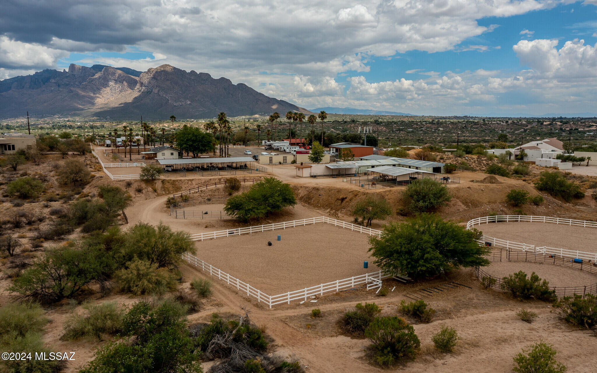 Three houses on a 10.06-acre horse-boarding property. Main house is a 4 BD/3 BA Hacienda-style home complete with a courtyard, pool, breathtaking mountain views, grass, & fruit trees. Two additional 3 BD/2 BA homes (1,991 & 1,152 SF) provide ample space for family or could be rented out for additional income. Northeast house was recently repainted. Main house is equipped with top-of-the-line Viking appliances and an updated kitchen. The roof was recently redone and partially painted inside. The property features extensive horse facilities—including trail access, three arenas, three tack rooms, and turn-outs—this is a haven for equestrian enthusiasts. detached 24'7x39'9 Garage w/24'10x39' Hay/Grain Storage, Barn Restroom, Mare Motels, & 45 Stalls.