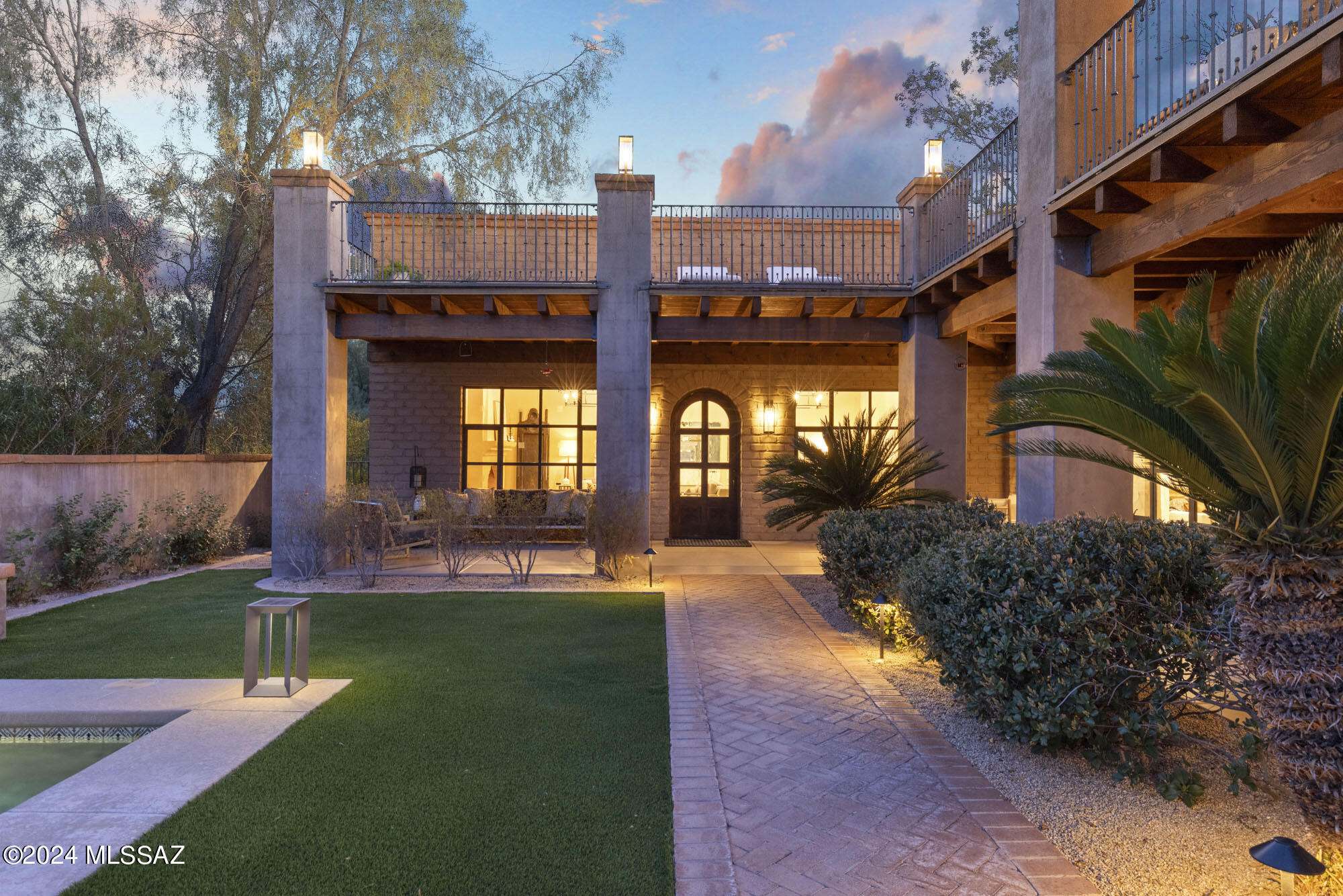 Impeccable quality construction & design is the hallmark of this gorgeous adobe tucked inside a privately gated courtyard in a prime Catalina Foothills location. Lovingly remodeled by the current designer/artist owner, every detail is perfection: brand new kitchen w/ the highest quality custom cabinetry, new appliances, luxe finishes & stunning tile work all connected to an elegantly comfortable Great Room w/walls of windows & glass doors all leading to the lush courtyard.Viga beamed ceilings, gleaming scored concrete floors, Venetian plaster walls that glow w/abundant natural light by day & golden custom lighting at night. Sumptuous primary suite features glass doors leading to view terrace, herringbone wood floors, spa-like bath w/ Italian Terrazzo tile. Detailed list of features avail.