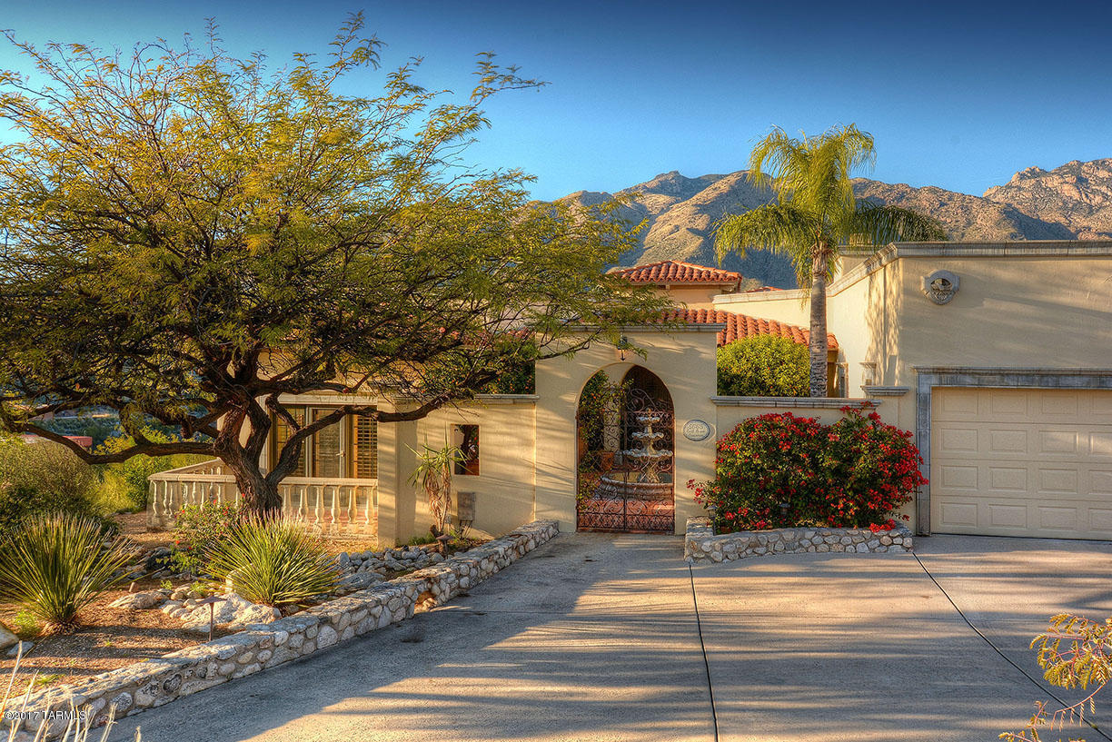 Perched near the top of Cimarron Foothills Estates  you will enjoy Magnificent Mountain views from this gorgeous Spanish Colonial home. Situated on 1.9 acre, you will have the privacy you crave!  The updated eat-in kitchen has a large island and beautiful counter tops of classy chiseled edge granite. Appliances include a Wolf Stove and SubZero fridge. Generous Master Suite has its own sitting room and large bath and a fireplace.  Beamed ceilings all through the home and wonderful niches for personal touches.  The 4th bedroom has a built in desk and shelving, so makes a great office. Outside is a pebble tech pool and spa, lovely landscaping, city lights and great mountain views. Some photos have been virtually staged so you can see how awesome this house will look when YOU live here!