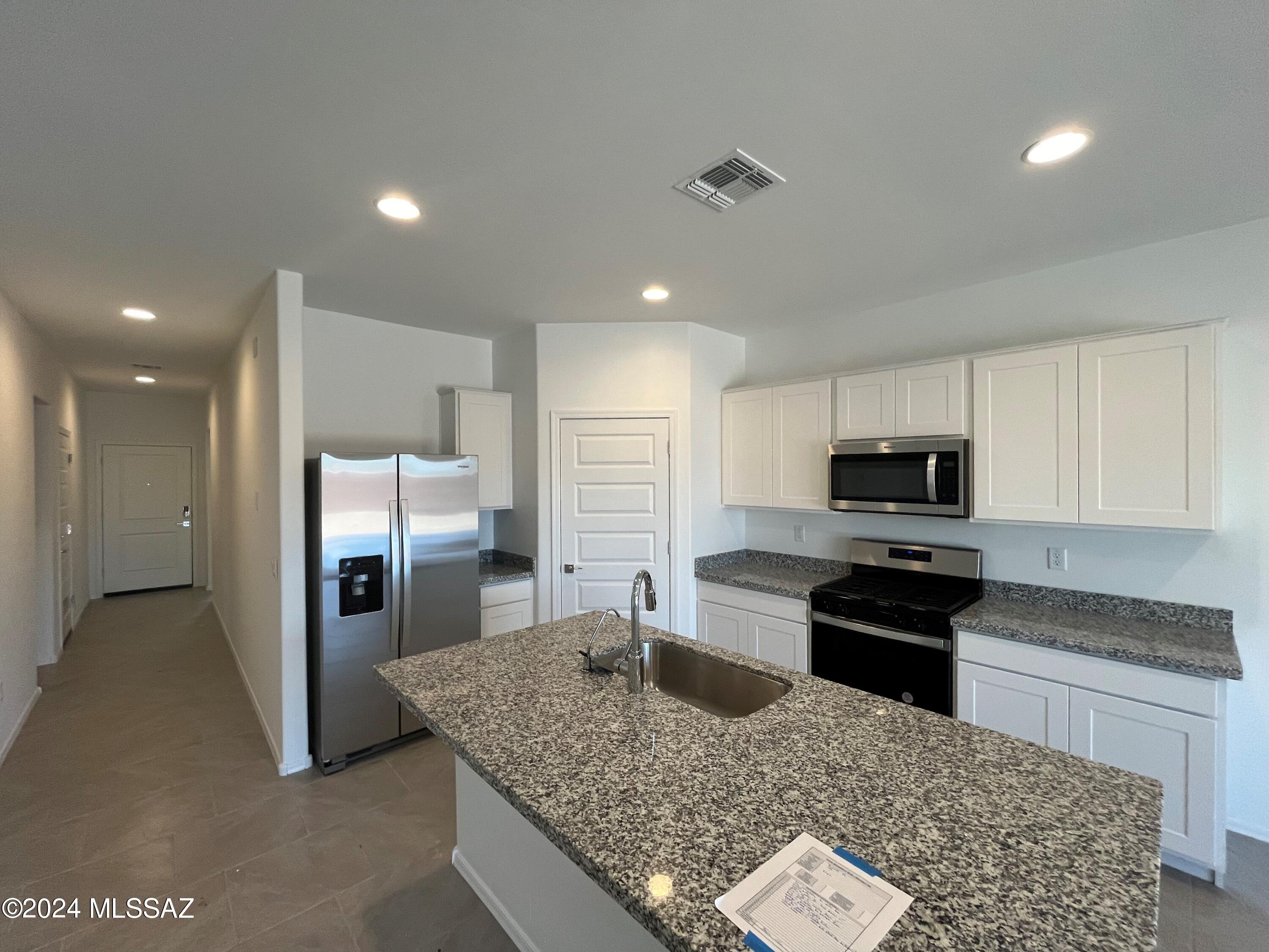 Newly listed and designed for comfort and convenience, this splendid 1,701 sqft home in Barnett Village promises a lifestyle of ease and refinement. Featuring 4 well-sized bedrooms and 2 full bathrooms, this house is perfect for anyone looking to enjoy stylish living within a serene neighborhood.
The heart of this home is undoubtedly its open-concept great room, bright and welcoming, that flows seamlessly into a cozy dining area and a sophisticated kitchen. Boasting an expansive island and  gray shaker cabinets, the kitchen is equipped with granite countertops and stainless-steel appliances, including a dishwasher and stove and microwave - a dream for culinary enthusiasts! Adding to the functionality,