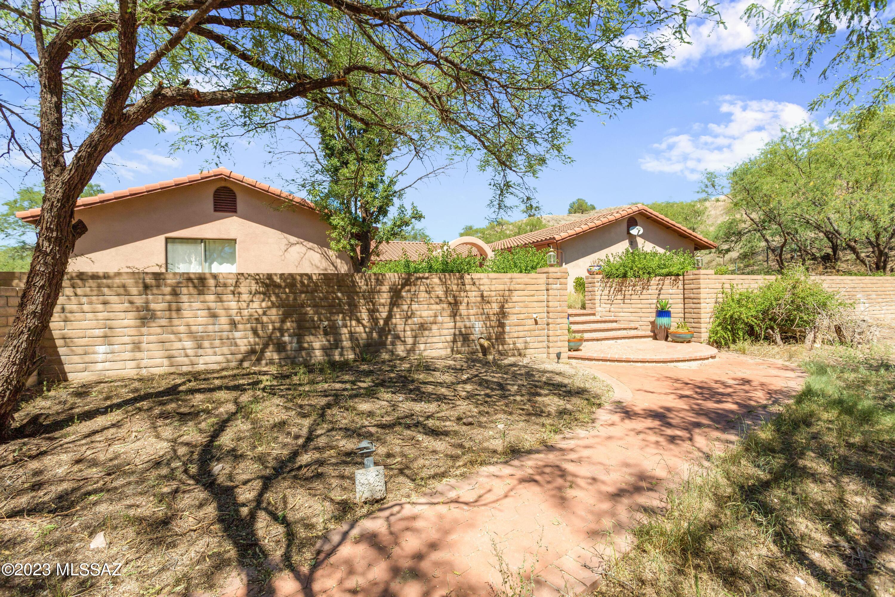 PRIVATE Ranch & Hacienda, over 80 acres in Historic Crown C. Sprawling equestrian sanctuary located in the heart of Arizona wine country! Estate features a secluded 2503 sqft custom built Spanish style hacienda. Through the grand double-gate, enter the main house with great room full of natural light, looking out over back patio and large sparkling pool. Down the eastern corridor find the primary bedroom with ensuite, 2 spacious guest rooms with jack & jill full bath, custom cabinetry and new carpet throughout. Central courtyard features a beautiful mission style fountain, and leads to attached 855 sqft Casita. Facing the courtyard is your 4-stall barn with turnouts, adjacent to corral. Additional features-Oversized RV garage, additional RV pad, and in-ground pool. Welcome to YOUR Oasis! Privacy! Beyond courtyard, find the walled-in front yard with mesquite trees, with room for dogs and kids to run. Your 4 stall block stable with tack room, turn-outs, and corrals meet the southern end of your yard. Beyond the corrals the two-stall block RV garage towers over additional corral fencing. North of the home find separate RV pad with water and power. Additional features include private drive just off HWY 82, virtually unlimited ride-out ability with access to Coronado National Forest, dynamite well with water beginning at 83 ft. Don't miss this stunning and secluded estate! HOA is $132 annually for road maintenance. Original building plans convey to easily make this hidden oasis your own. Welcome Home!