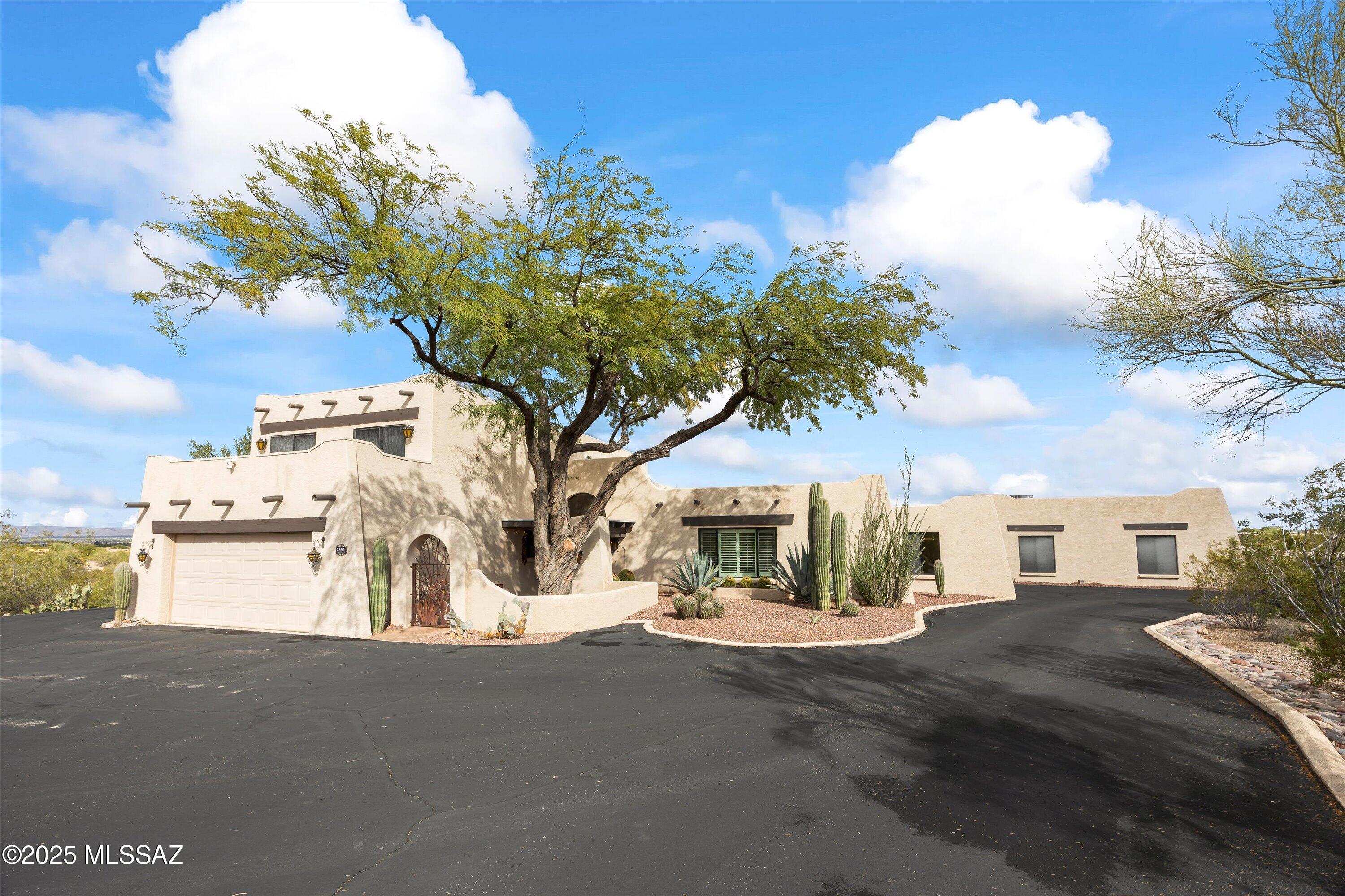 Perched on 4 acres of pristine cactus studded desert beauty, this 4-bedroom, 4-bath estate combines privacy, craftsmanship, and breathtaking Tucson Mountain and Catalina views. Designed for both comfort and sophistication, the home features sun-filled living spaces, serene bedrooms, and effortless indoor-outdoor flow to capture every sunrise, sunset and city lights. 2-car attached garage complements the temperature-controlled 6-car showcase garage—a rare find for enthusiasts and collectors alike. Tucked away yet minutes from shopping, dining, and hiking, this is luxury desert living at its finest—where panoramic views and modern convenience meet in perfect balance. Sports court available to repurpose for sporting desire. NO HOA or CCR's.