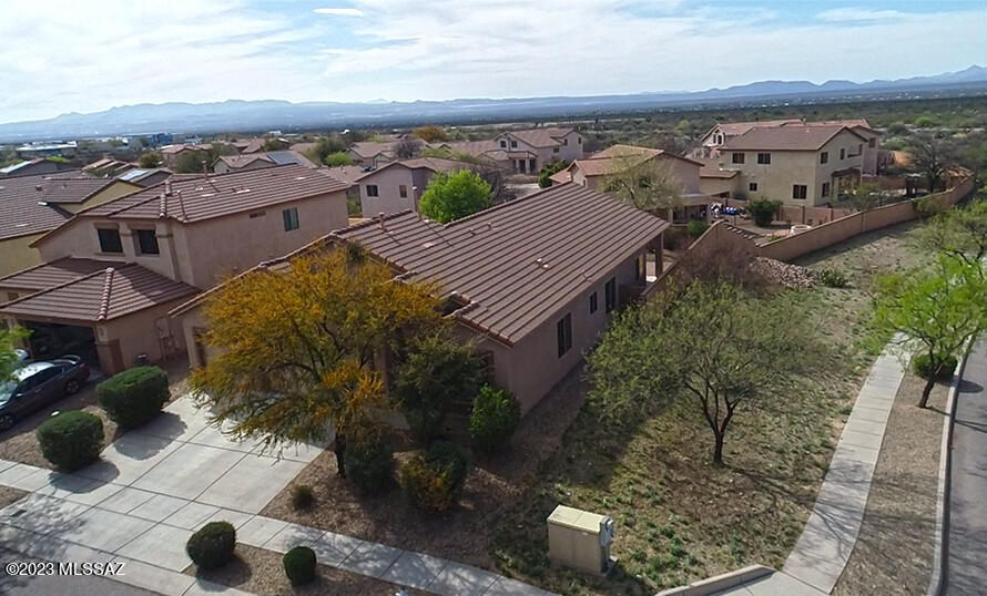 This popular 4 bedroom 2 bath home is nestled at the base of the Santa Rita foothills. This home checks all the boxes, 3 car garage, corner lot, gourmet kitchen with island, Jack and Jill bathroom, fully landscaped front and backyards. Our home features real wood flooring, plantation shutters, and corian countertops.  All of this situated just steps away from the community park, pool and Vail School Districts newest elementary school Copper Ridge.